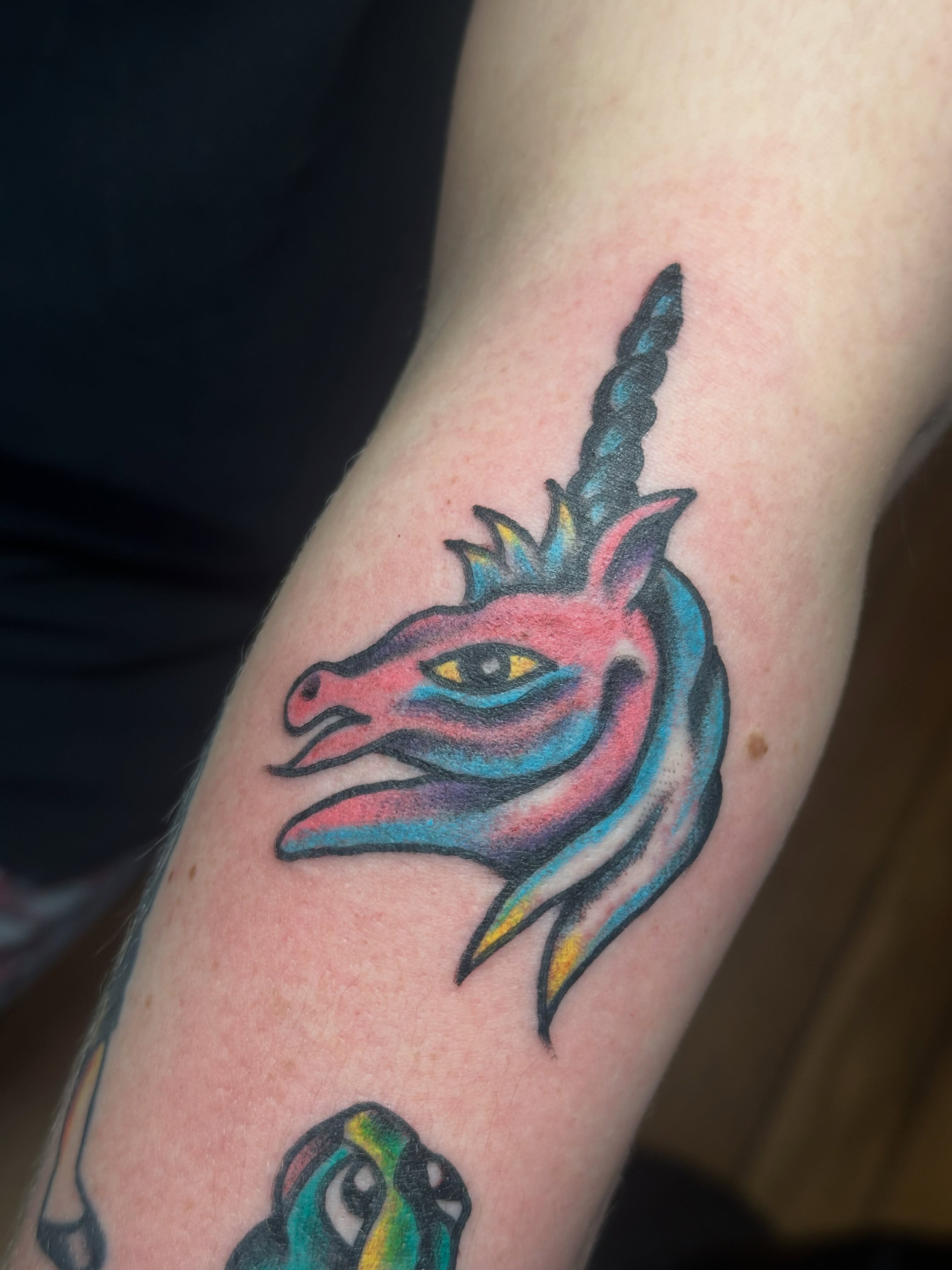 Unicorn new school tattoo on the forearm by Providence Tattooer