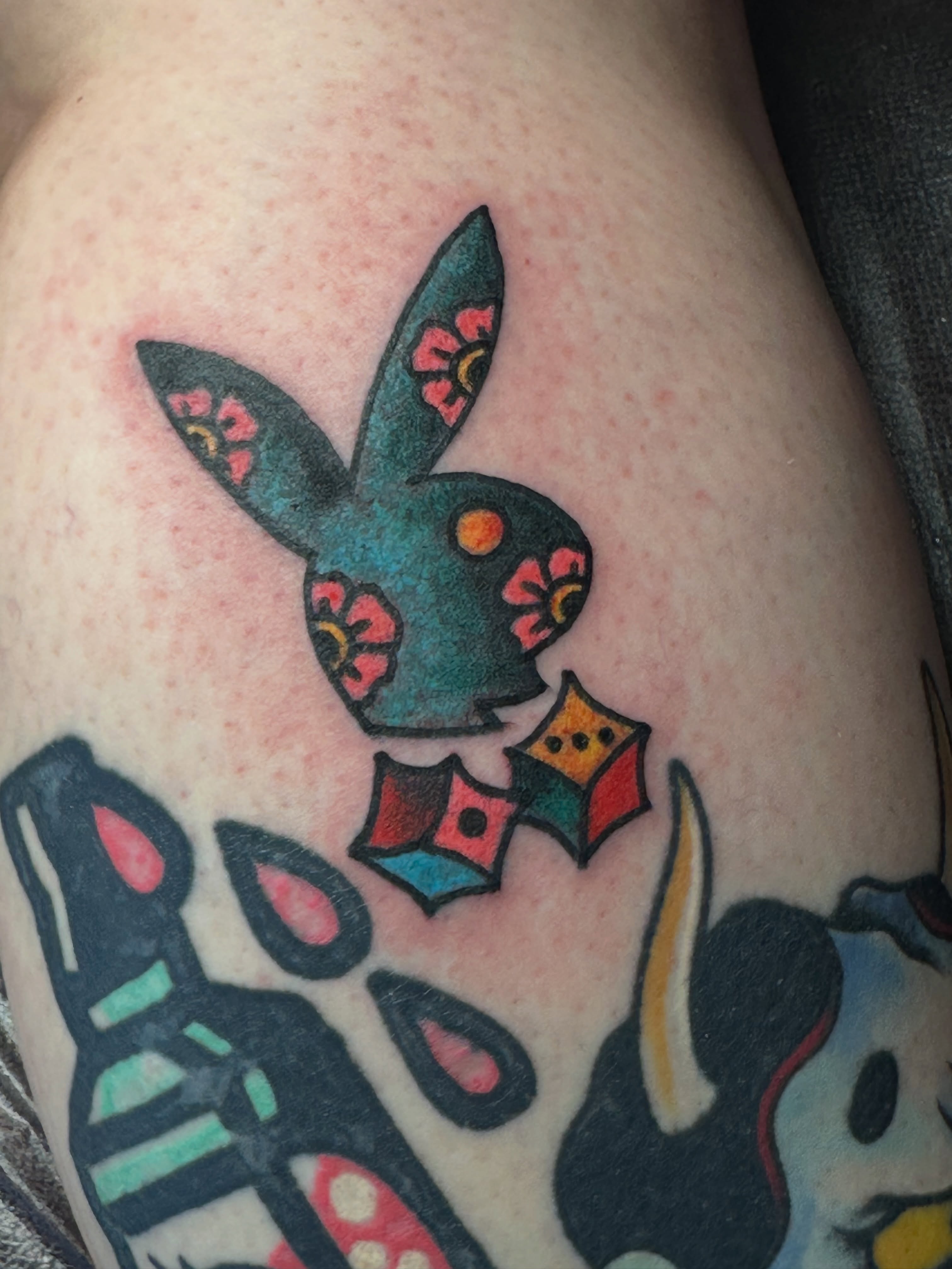 Playboy bunny American traditional tattoo on the thigh by Providence Tattooer