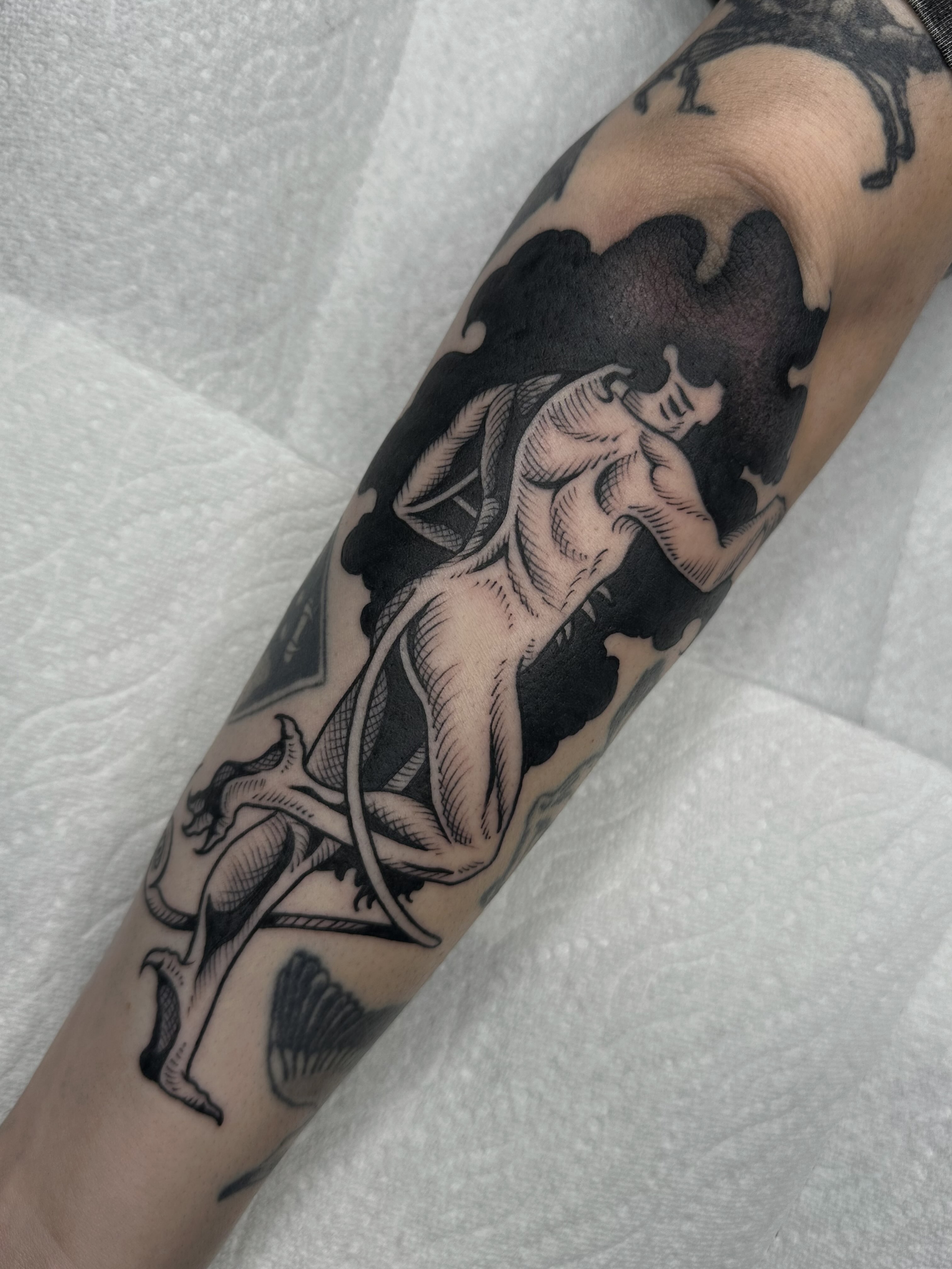 Mermaid black and grey tattoo on the forearm by Aleksandra