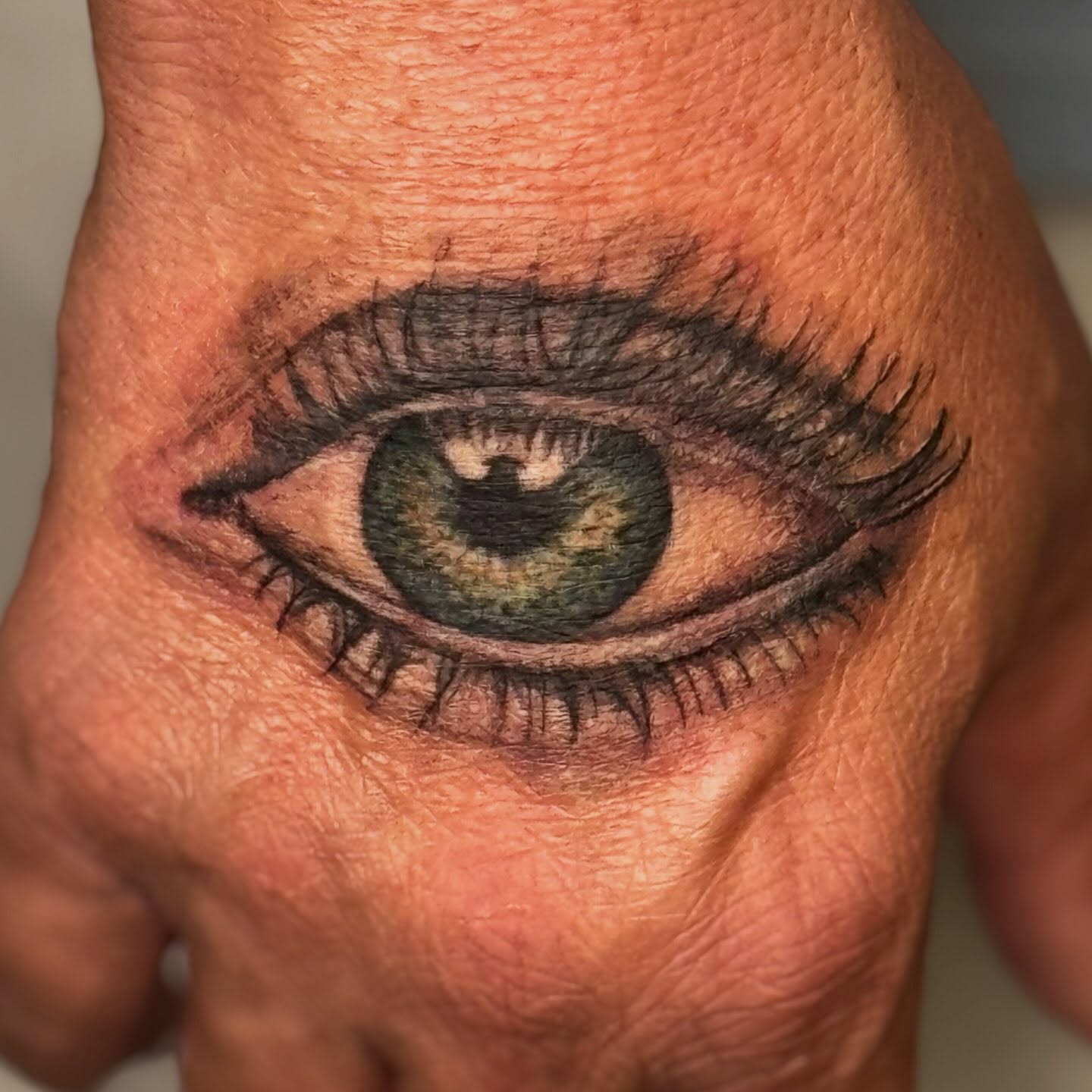 Eye realism tattoo on the hand by Elmer Lethco