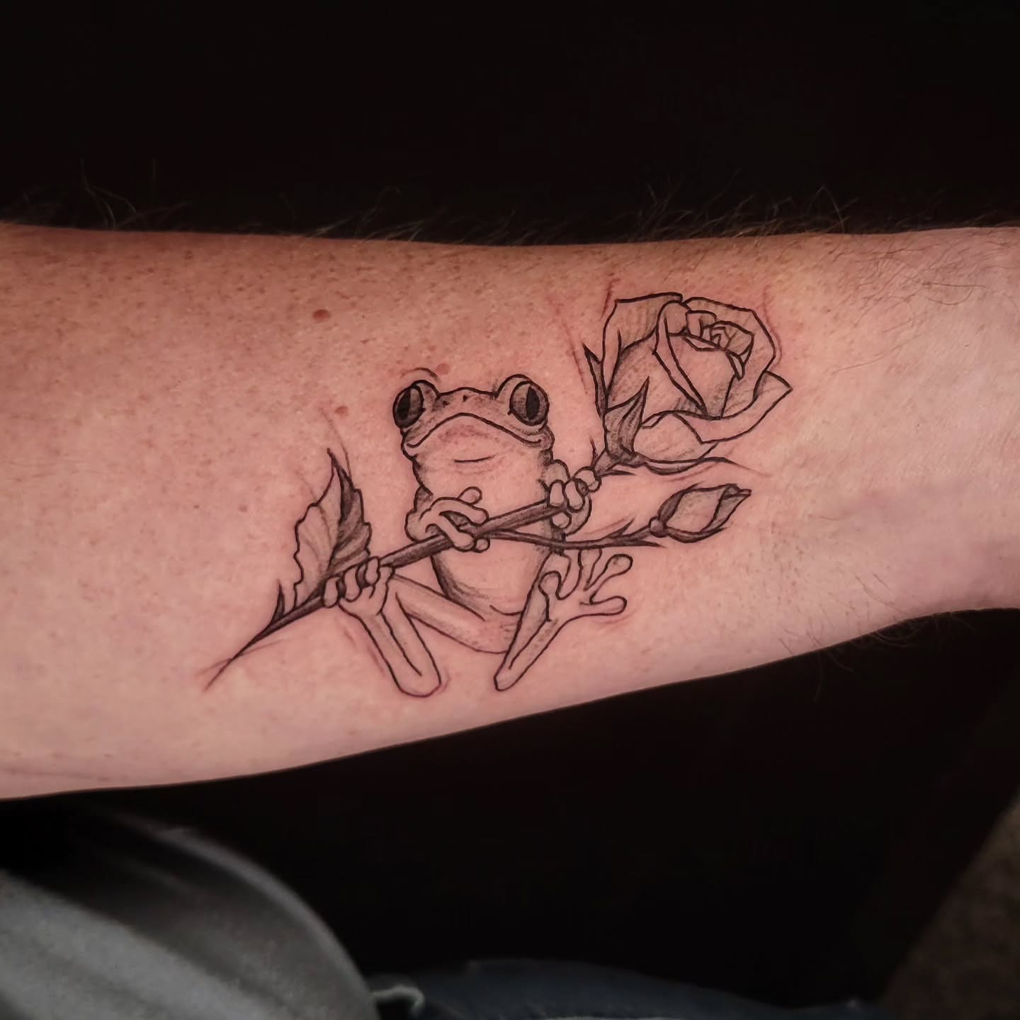 Frog and rose realism tattoo on the forearm by Sarah Alba