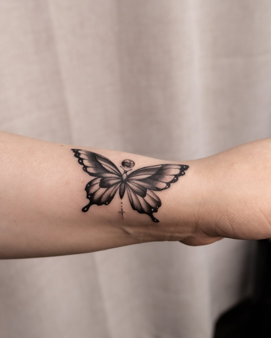 Butterfly black and grey tattoo on the forearm by Koko