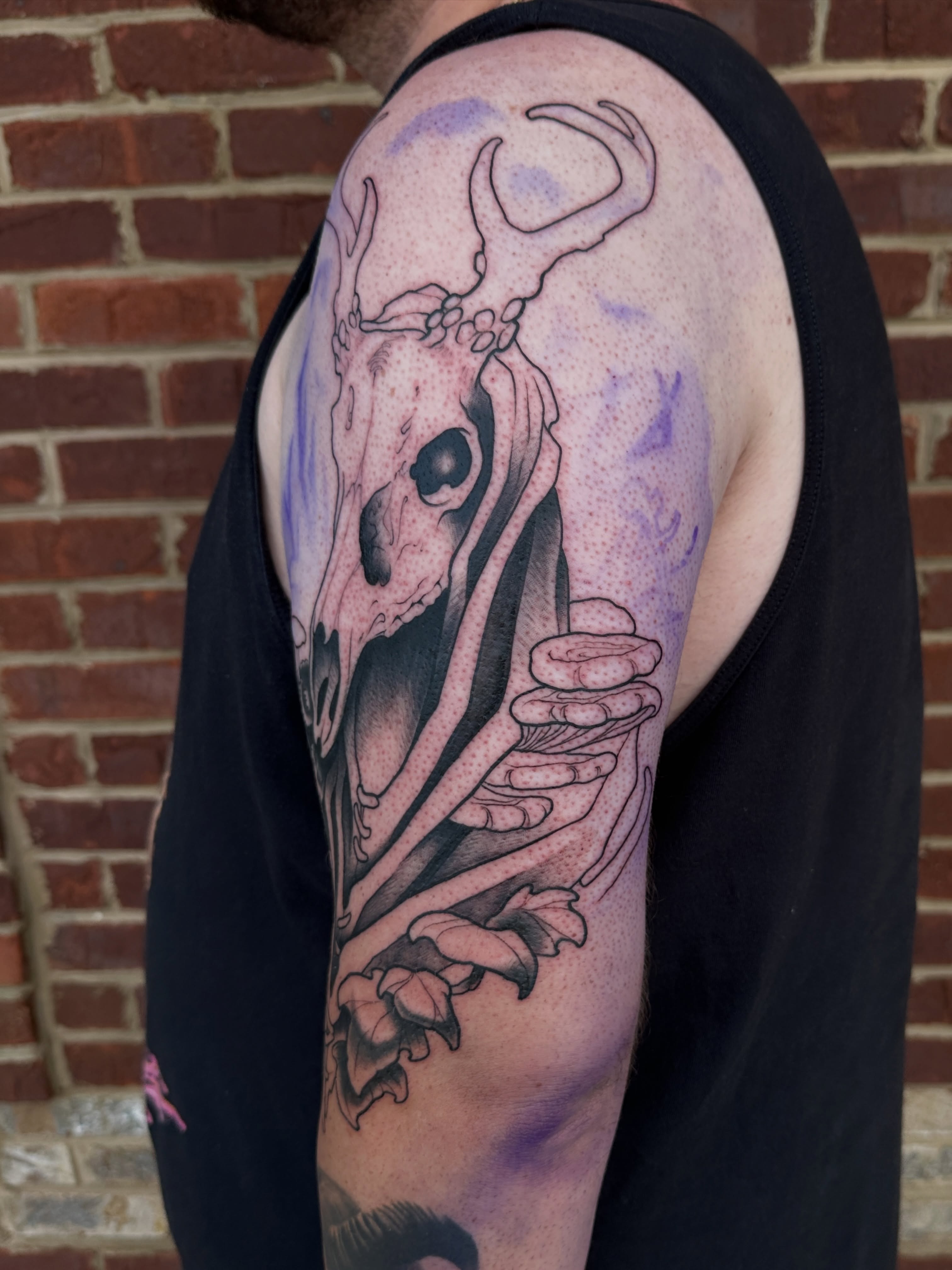 Deer skull and roses realism tattoo on the shoulder by Skylar Mangrum