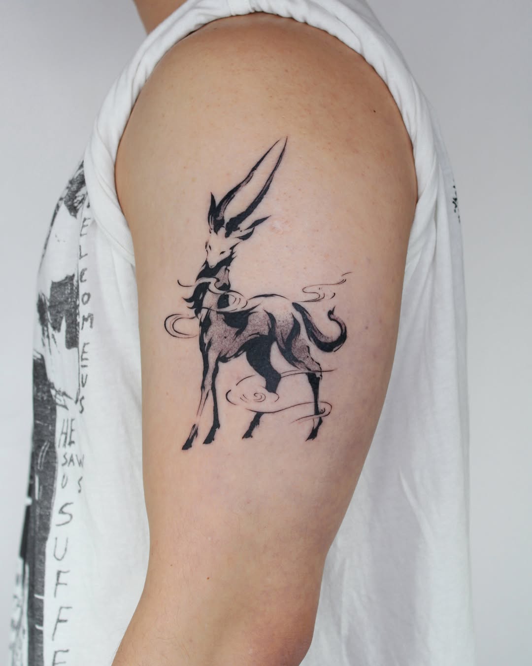 Stylized deer sketch tattoo on the upper arm by Piao