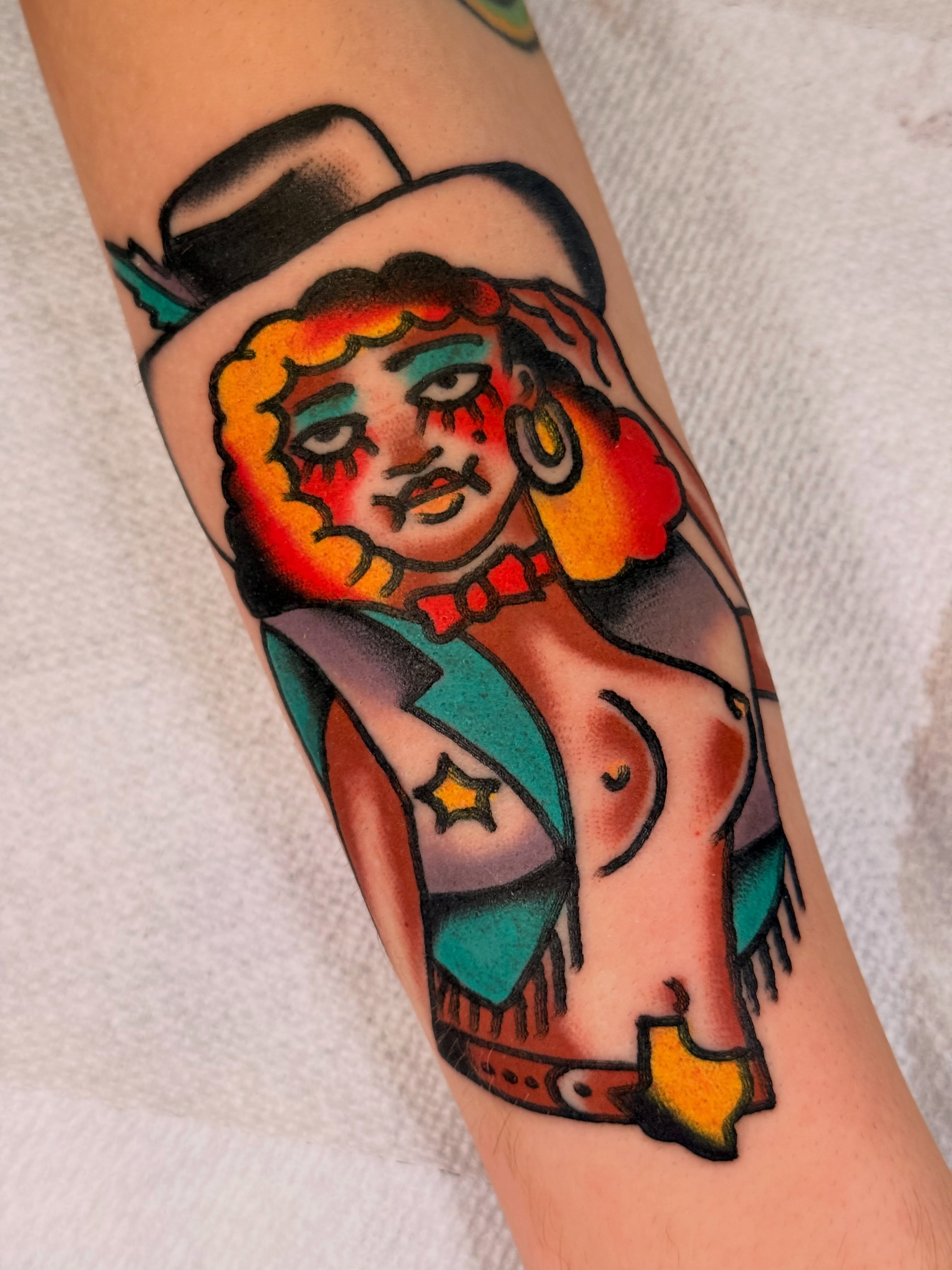 Cowgirl American traditional tattoo on the forearm by {{Theo Glanton}}