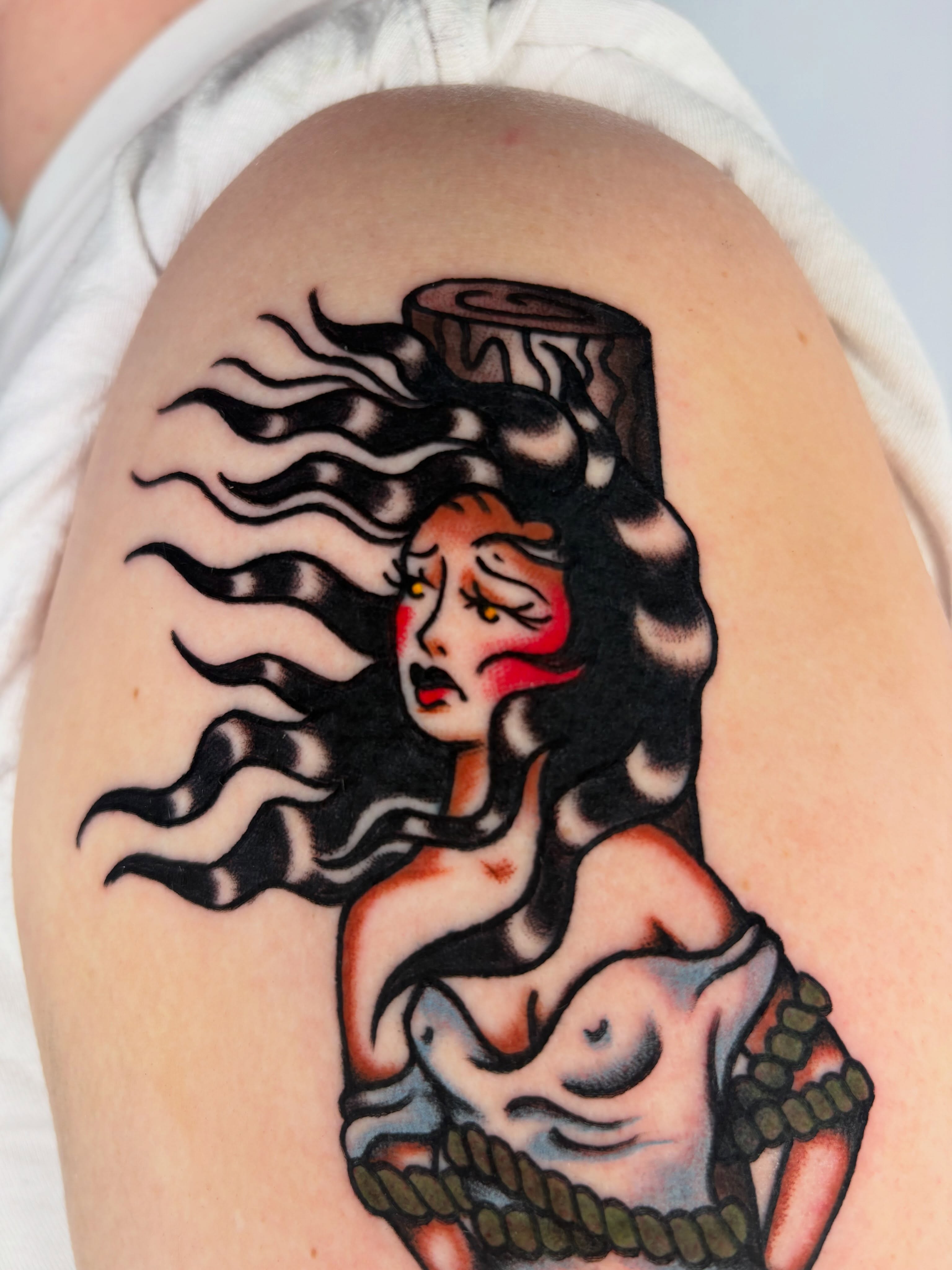 Woman with flowing hair American traditional tattoo on the shoulder by Lorelei