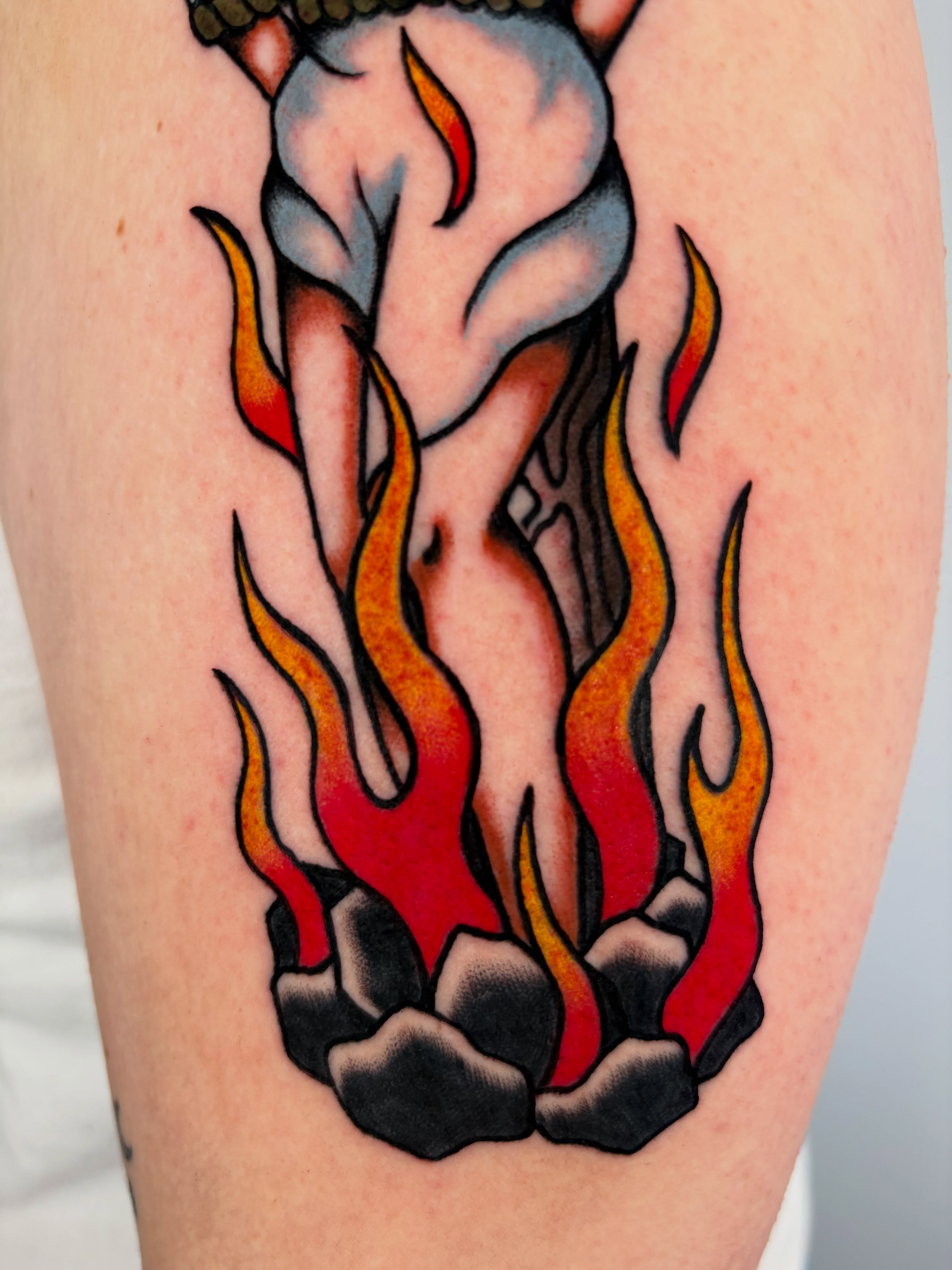 Flames and figure American traditional tattoo on the thigh by Lorelei