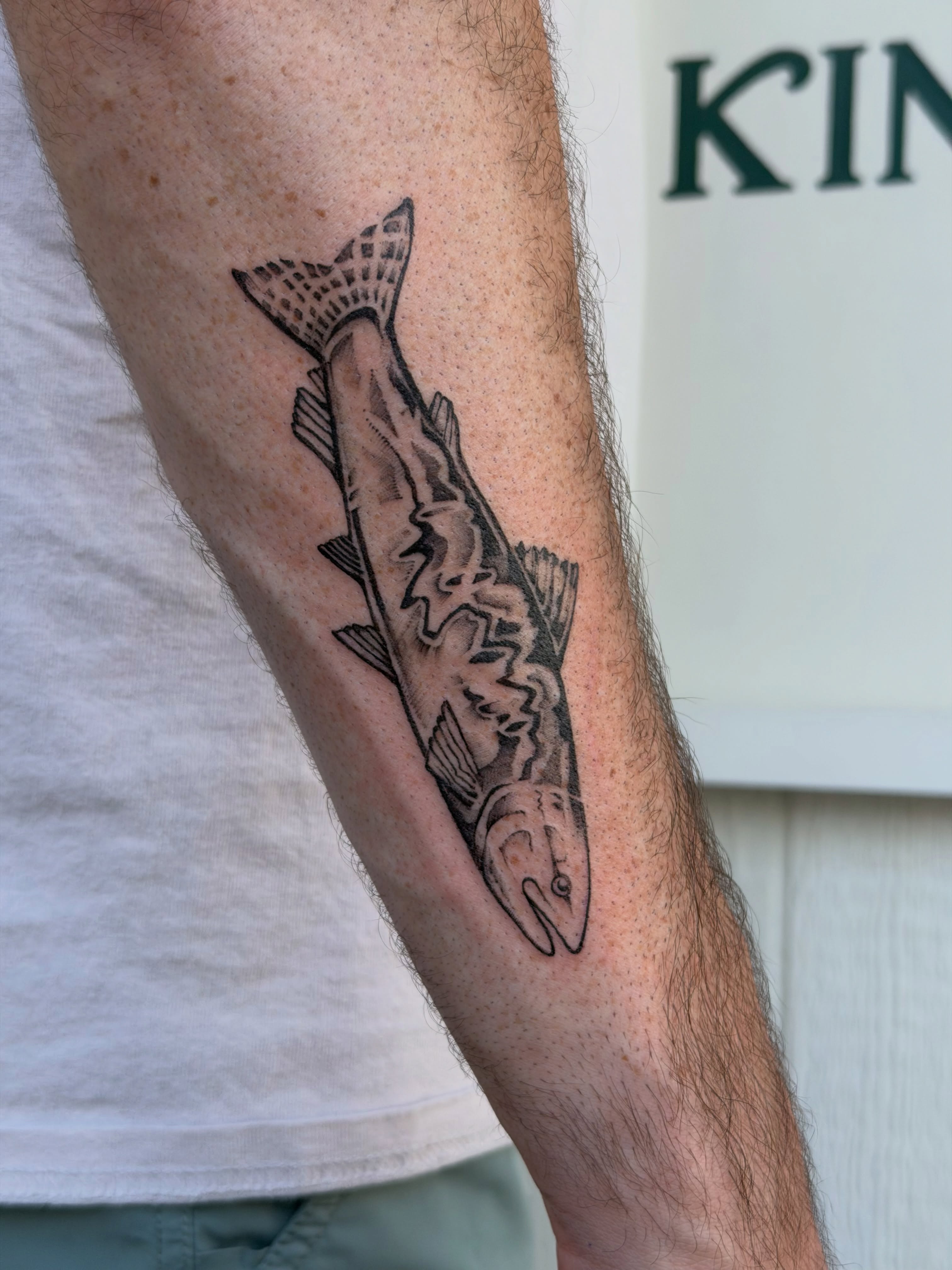 Fish black and grey tattoo on the forearm by Kingtide Ink