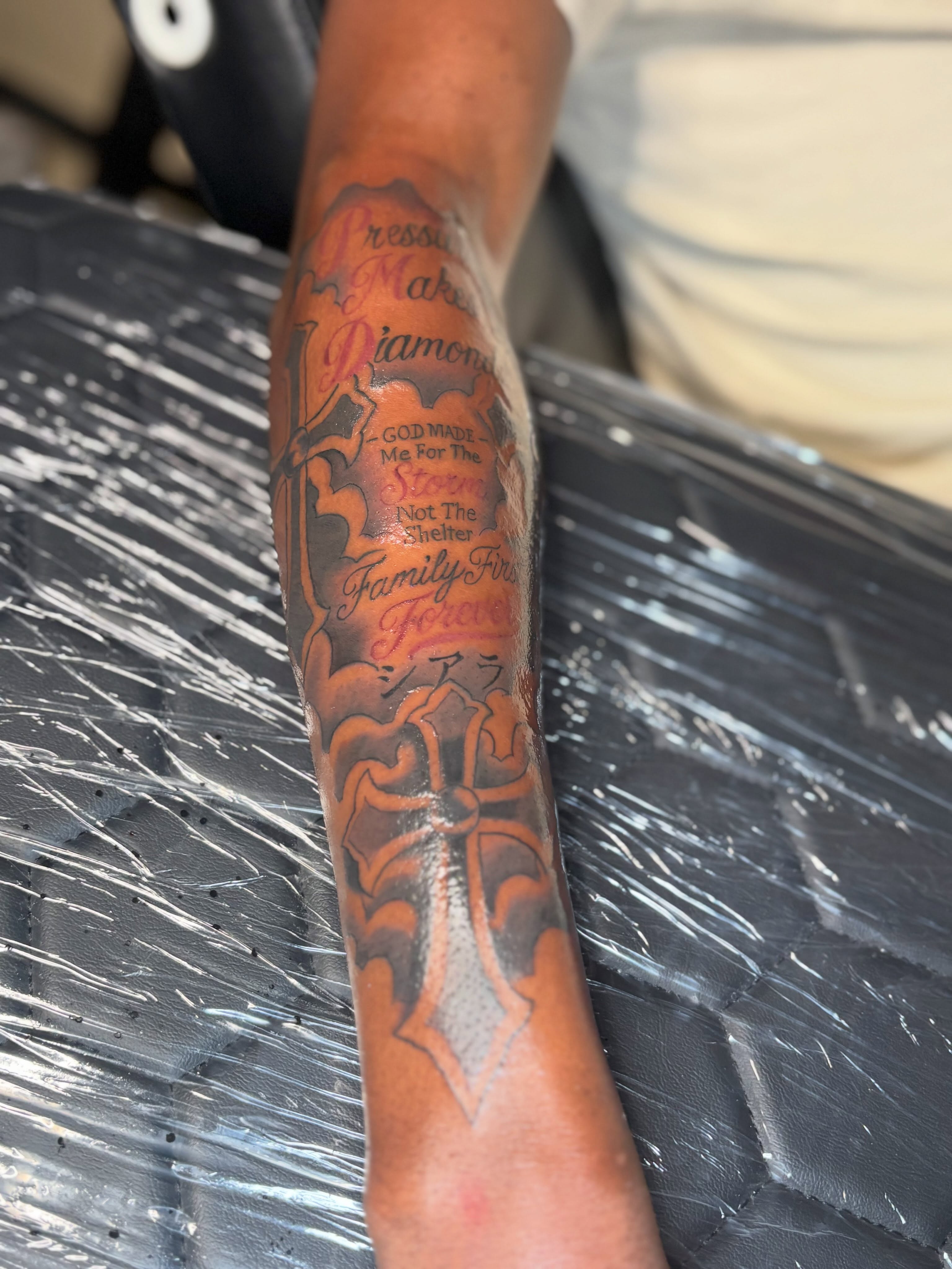 Cross and script American traditional tattoo on the forearm by Mr.K