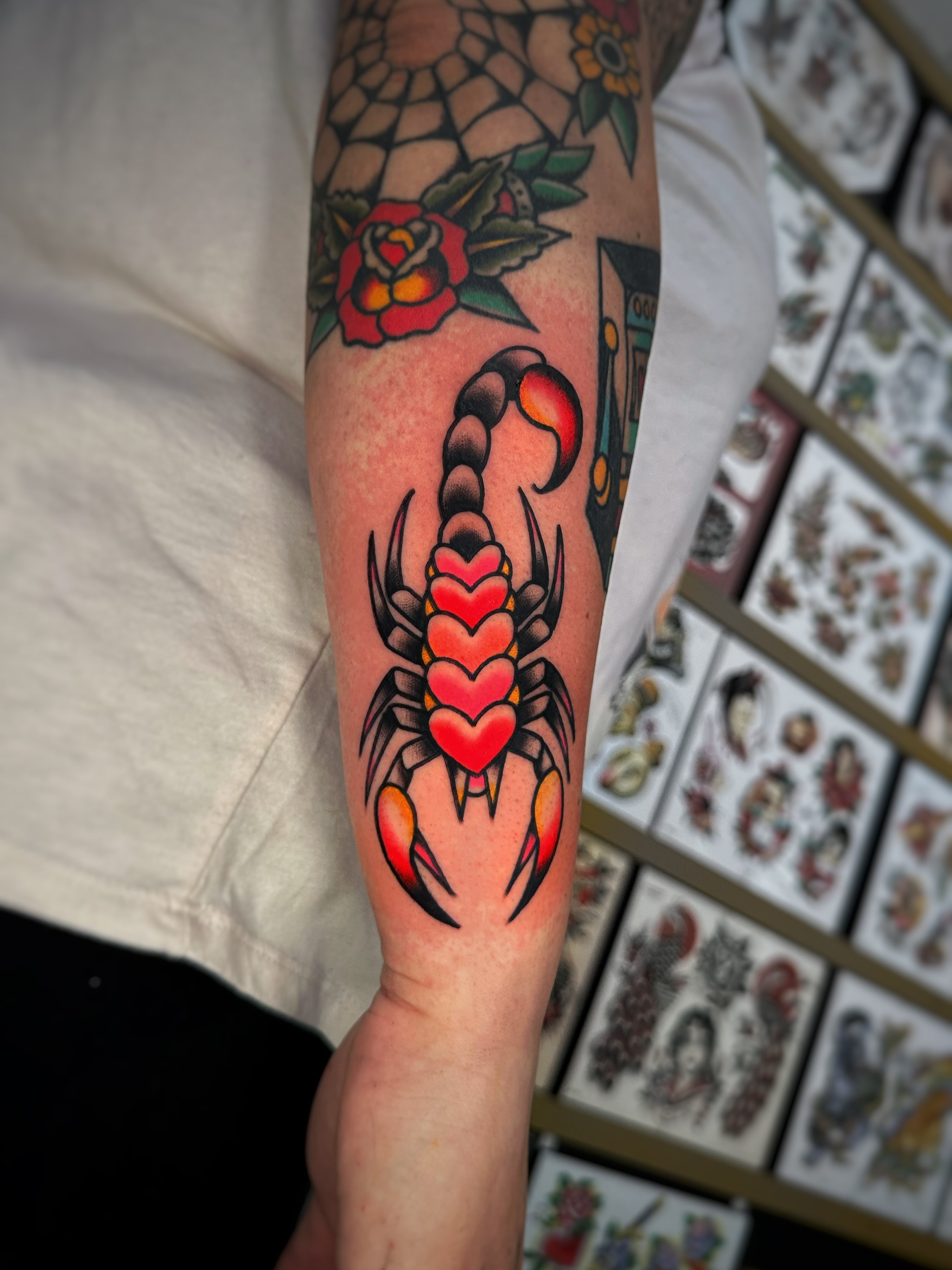 Scorpion with hearts American traditional tattoo on the forearm by Alex Finnerty, Reading, Massachusetts