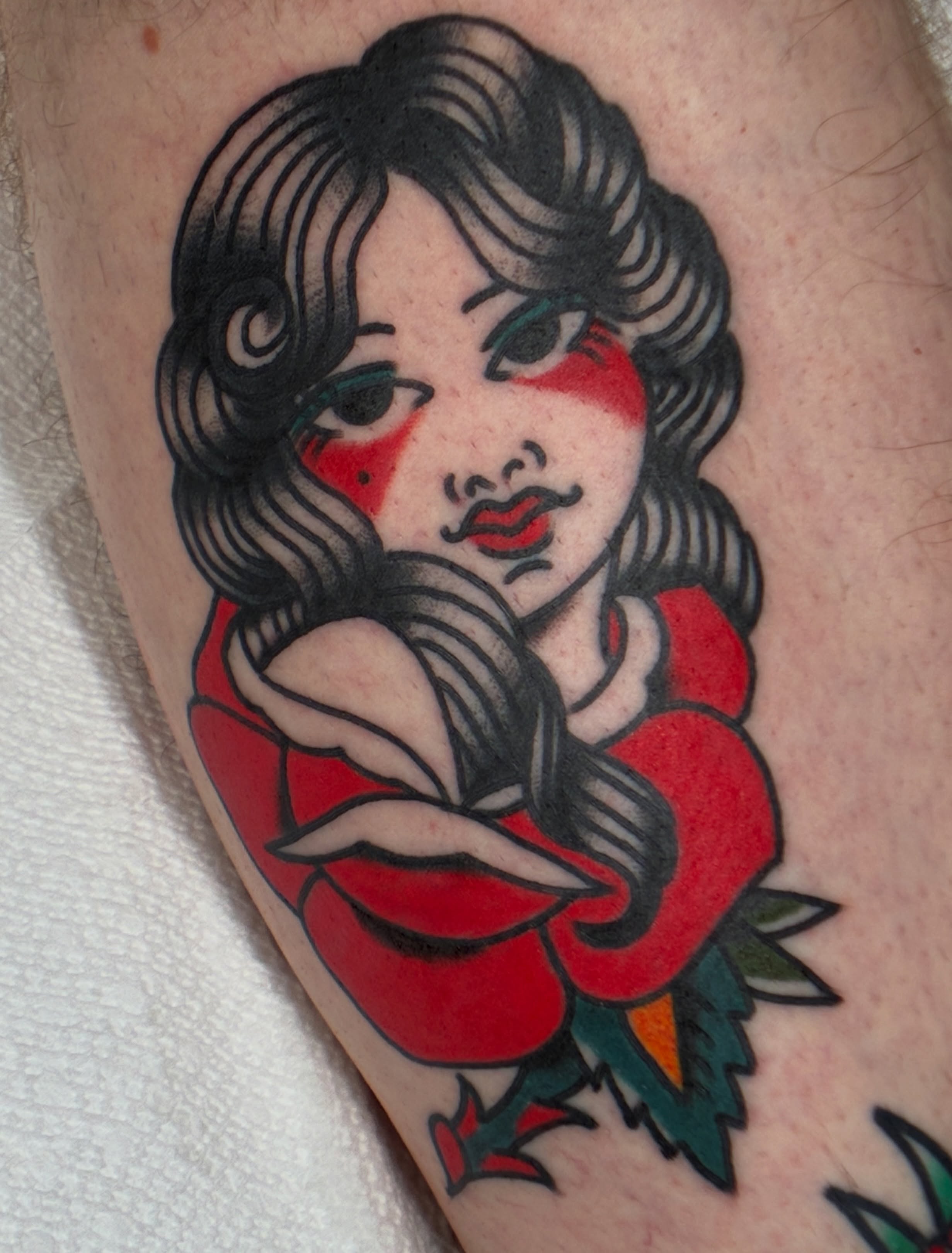 Woman with red rose American traditional tattoo on the forearm by Sav Robinson