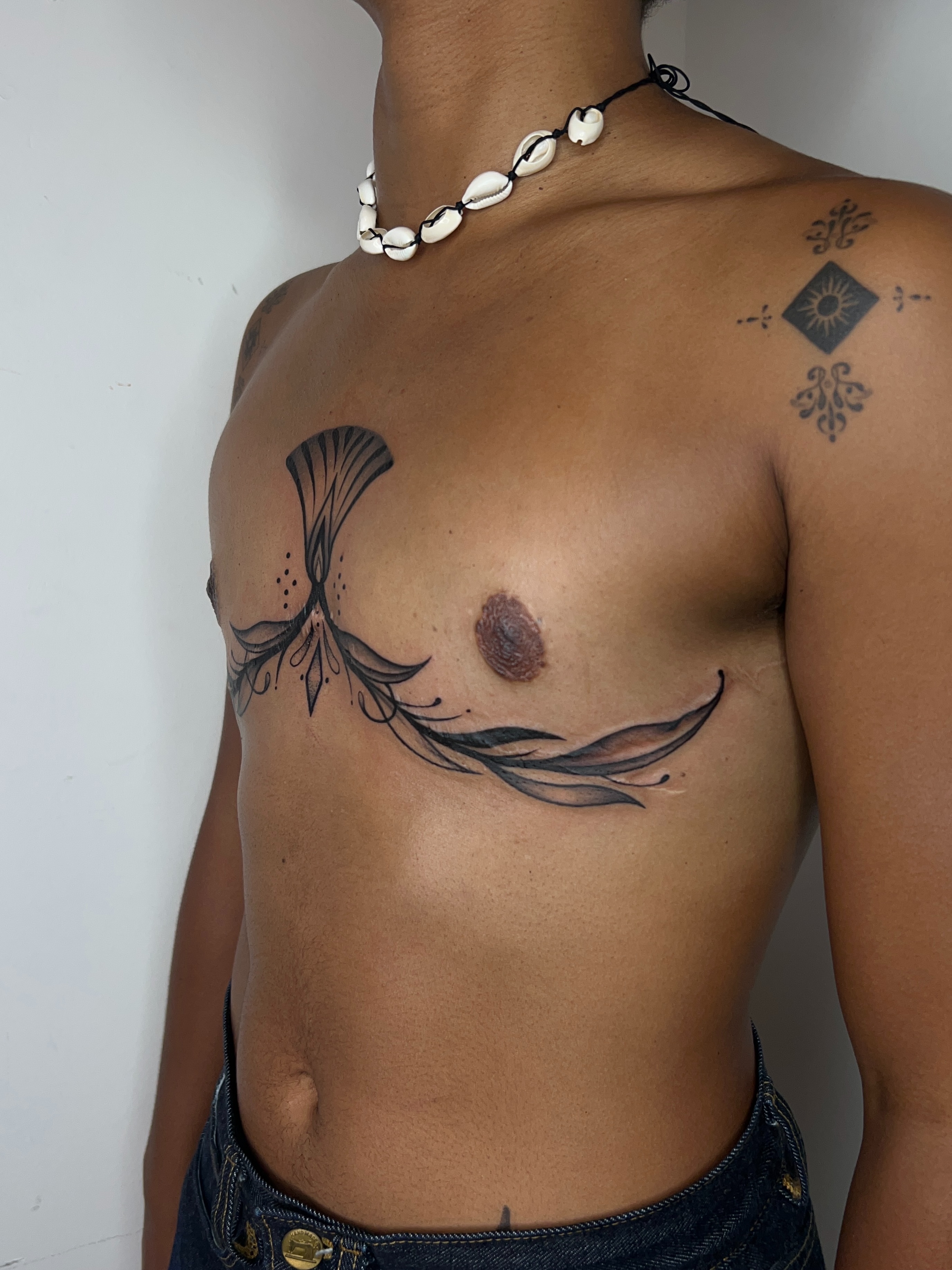 Abstract floral geometric tattoo on the chest by ༻𝐓𝐡𝐞 𝐒𝐤𝐢𝐧 𝐆𝐚𝐫𝐝𝐞𝐧༺
