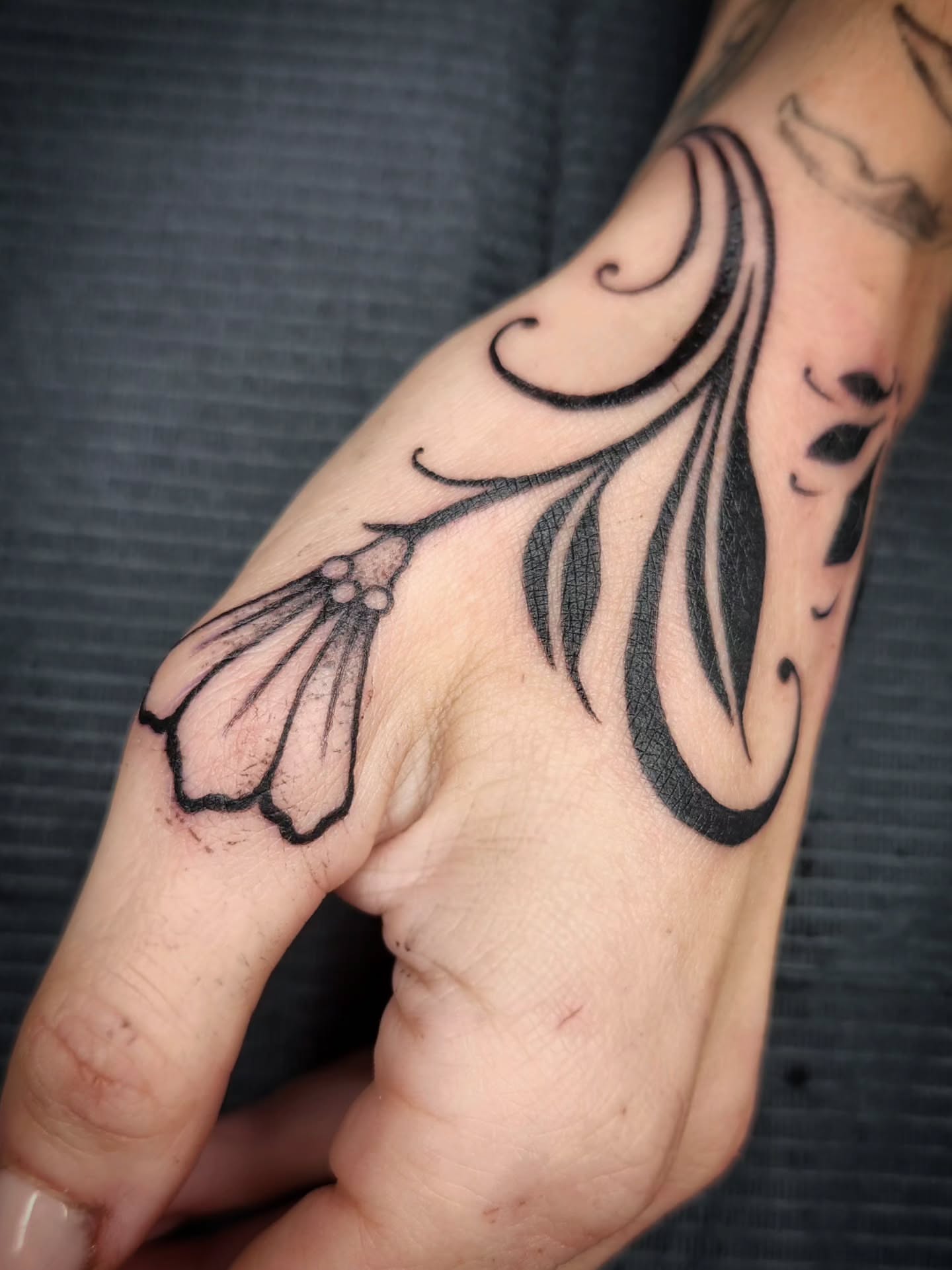 Floral design black and grey tattoo on the forearm by Kelly Zito