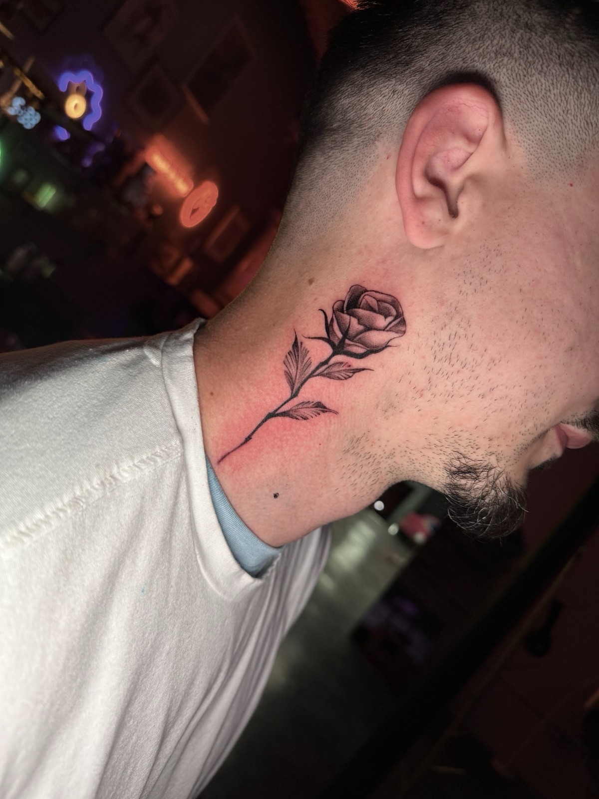 Rose black and grey tattoo on the neck by Tattoo Artist Vanessa