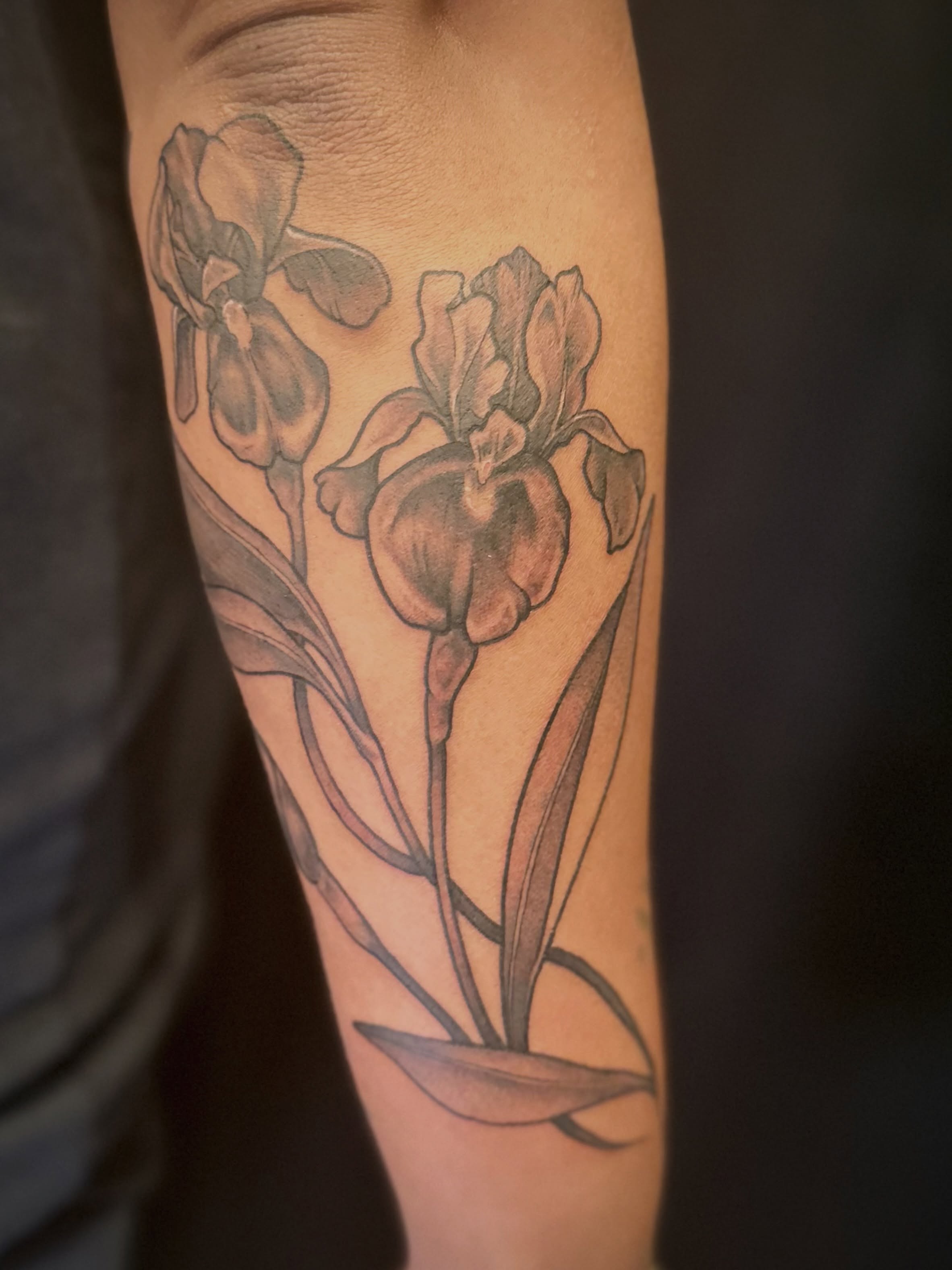 Iris flowers black and grey tattoo on the forearm by Maddie Morrill