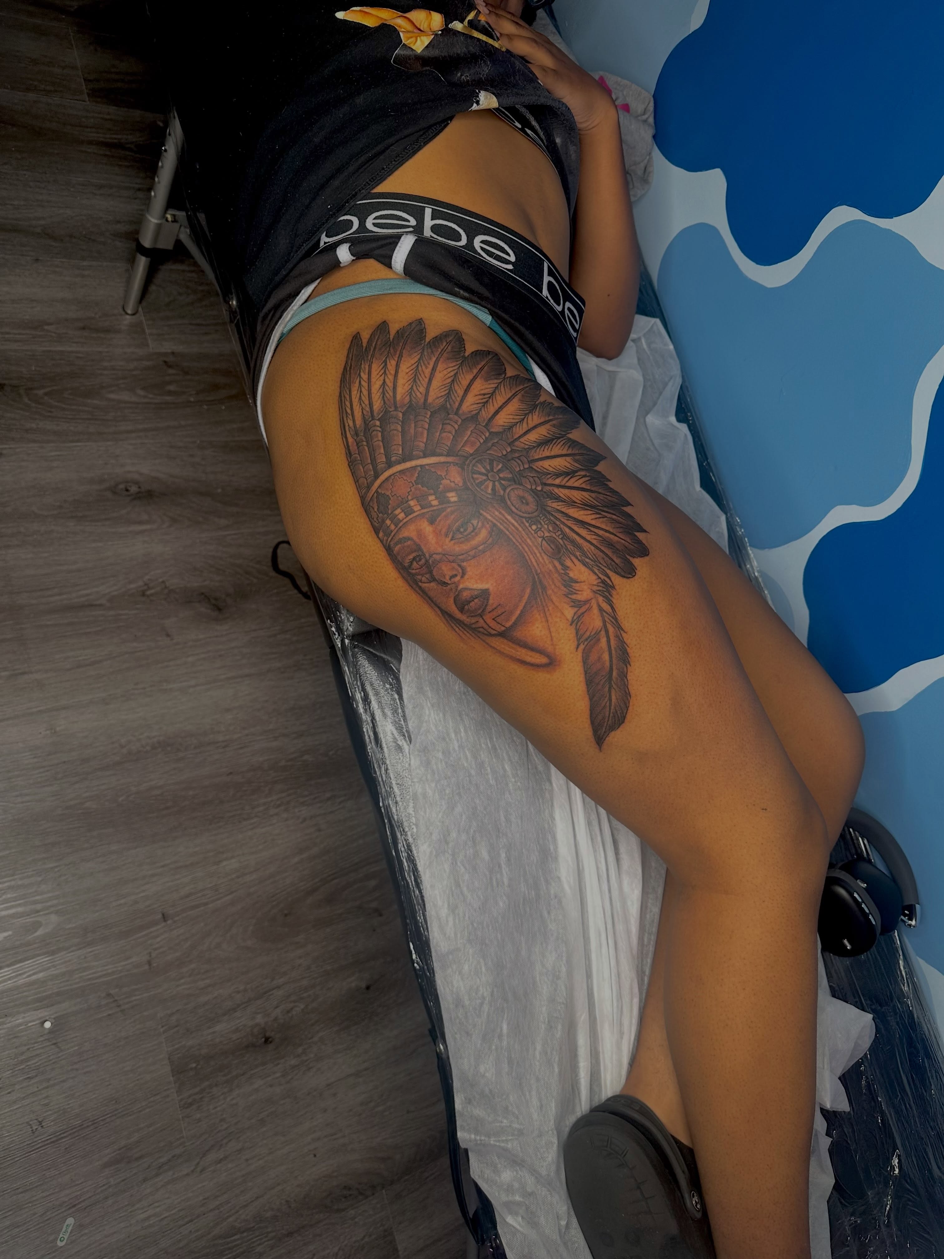 Indian headdress American traditional tattoo on the thigh by Sierra 🩷