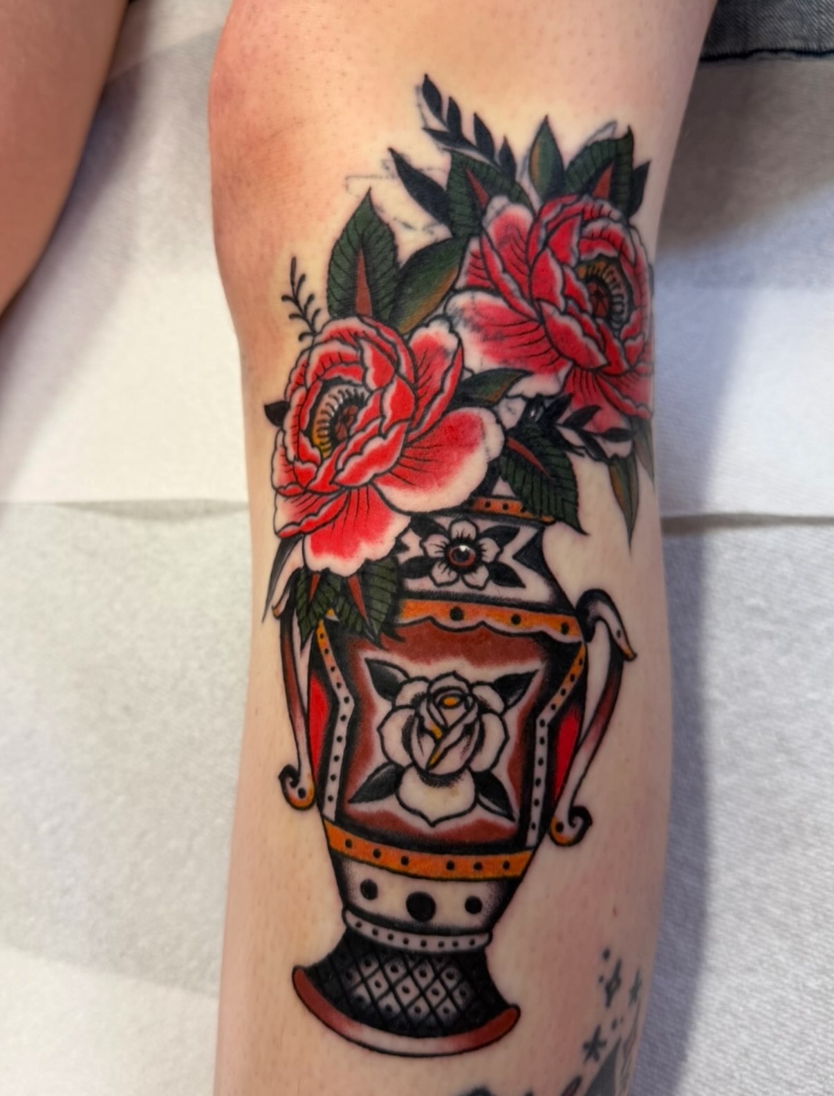 Vase with flowers American traditional tattoo on the forearm by David Evans