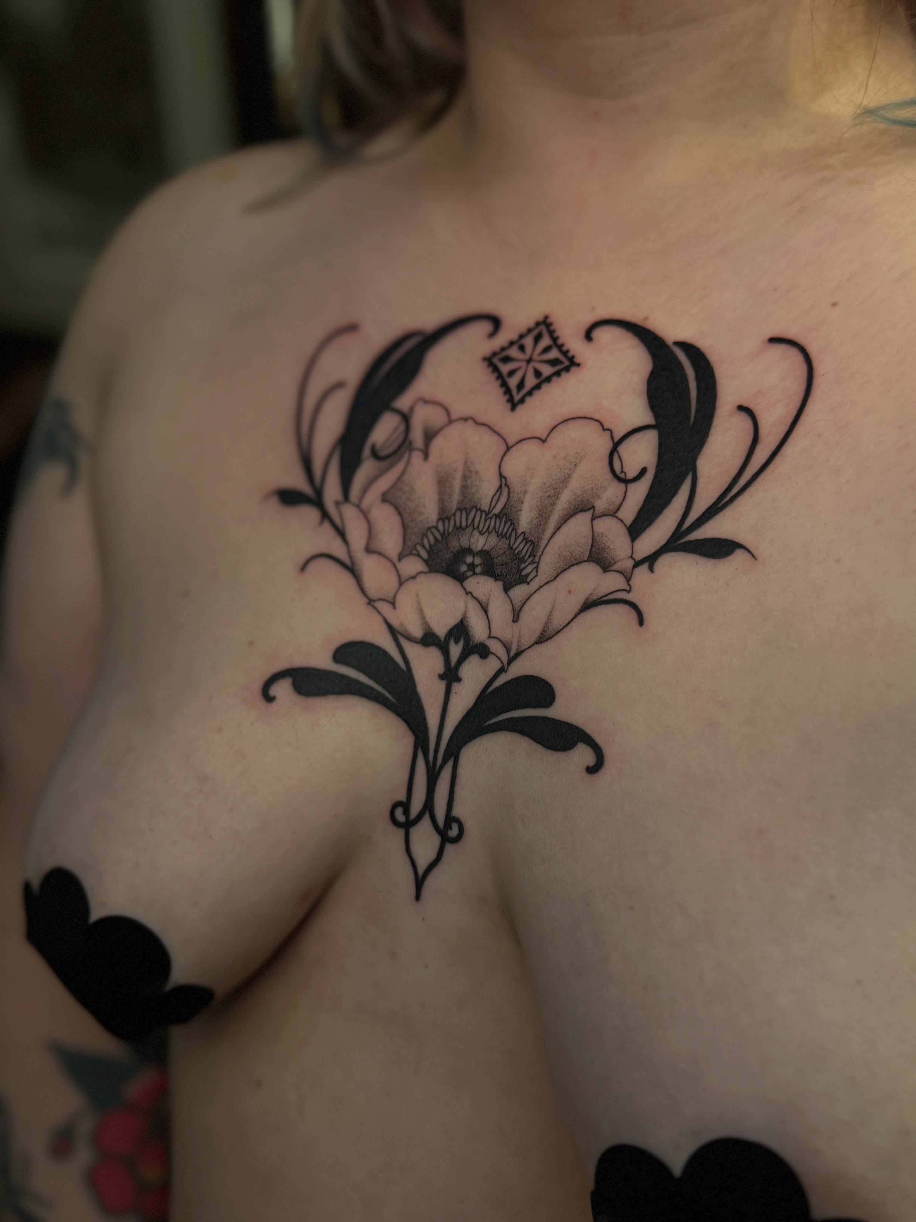 Flower black and grey tattoo on the chest by Virginia 🥀Neo Traditional