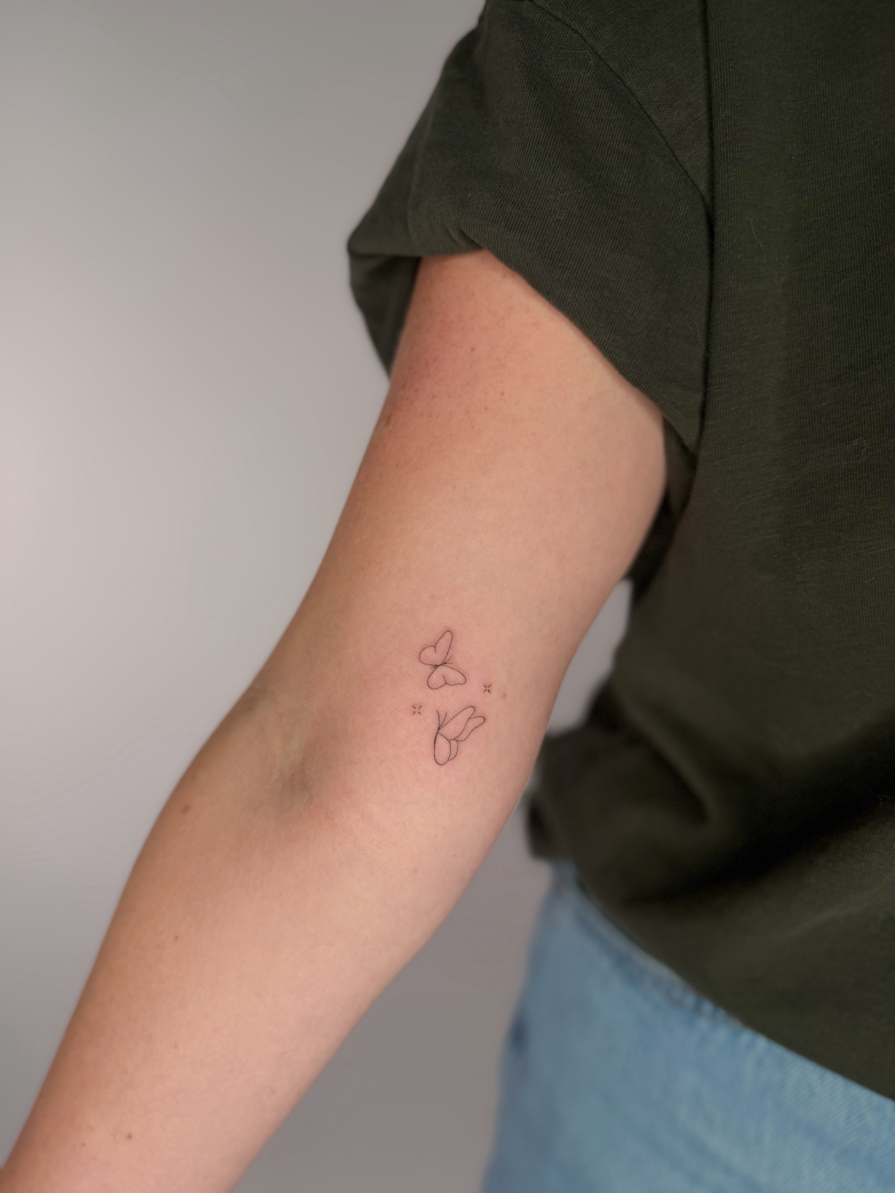 Butterfly fine line tattoo on the forearm by Fineline Tattoos DFW