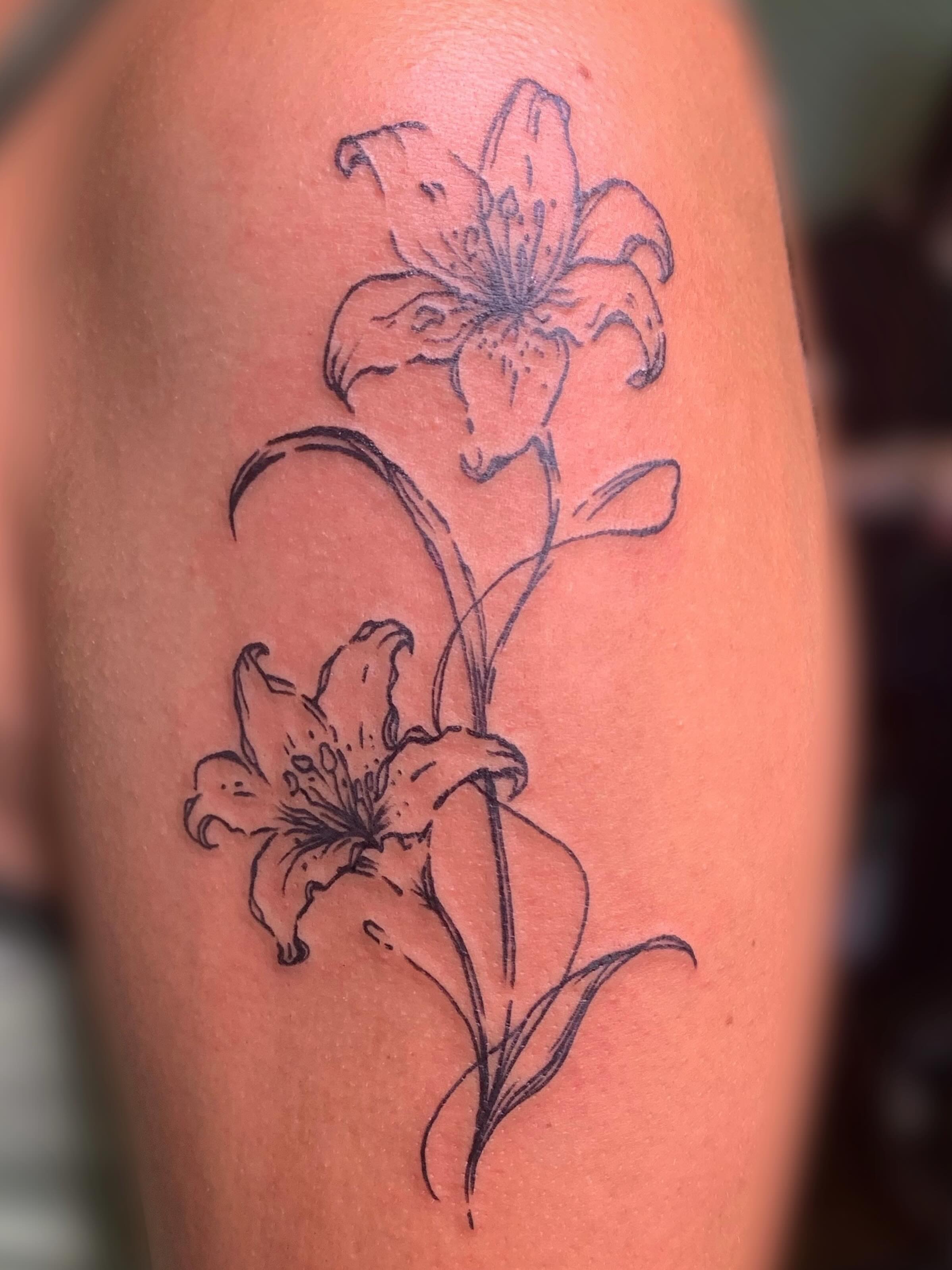 Lily black and grey tattoo on the forearm by Ava Glory Tattoos