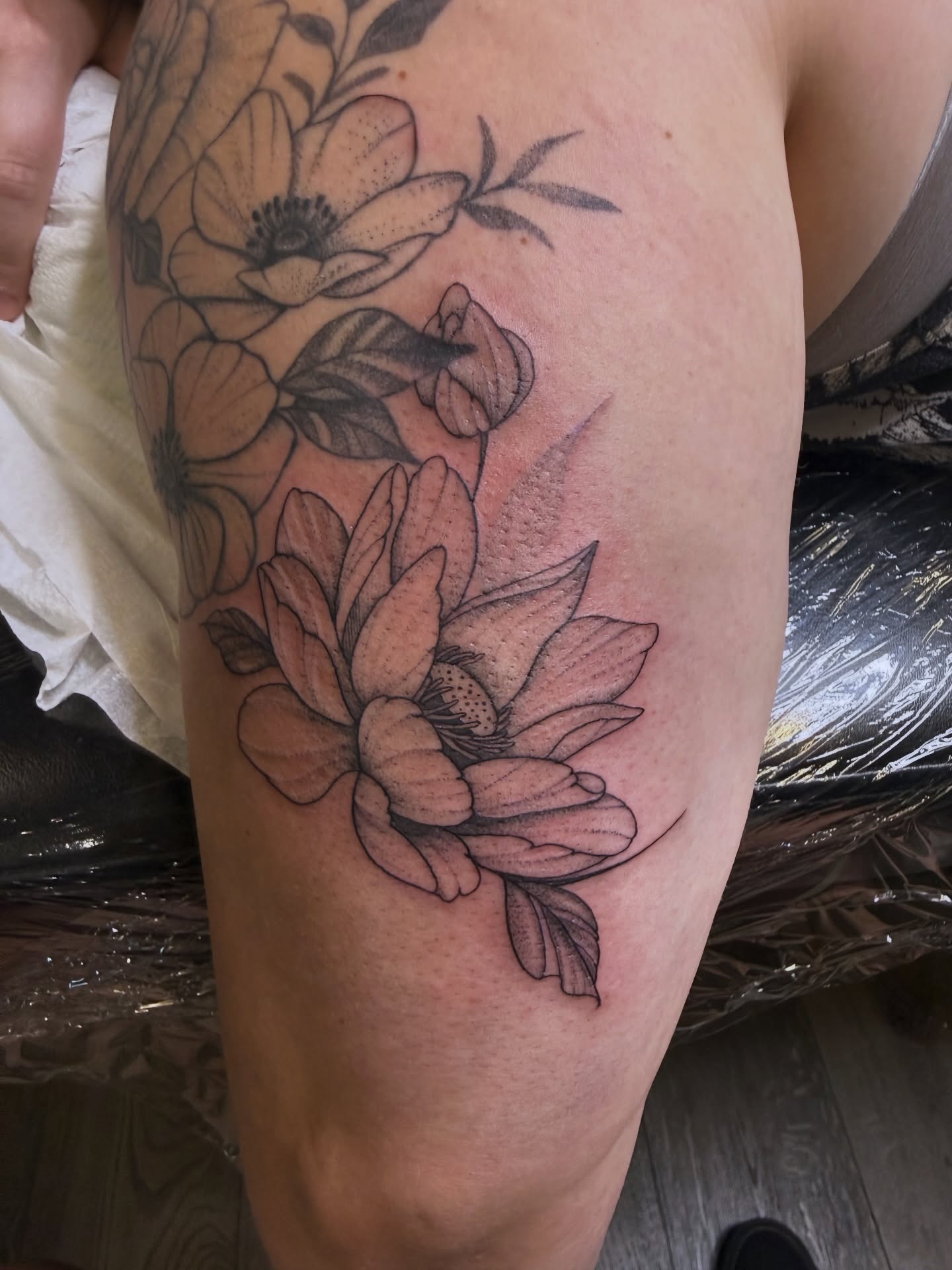 Lotus flowers black and grey tattoo on the thigh by WhoisLaineyTattoos