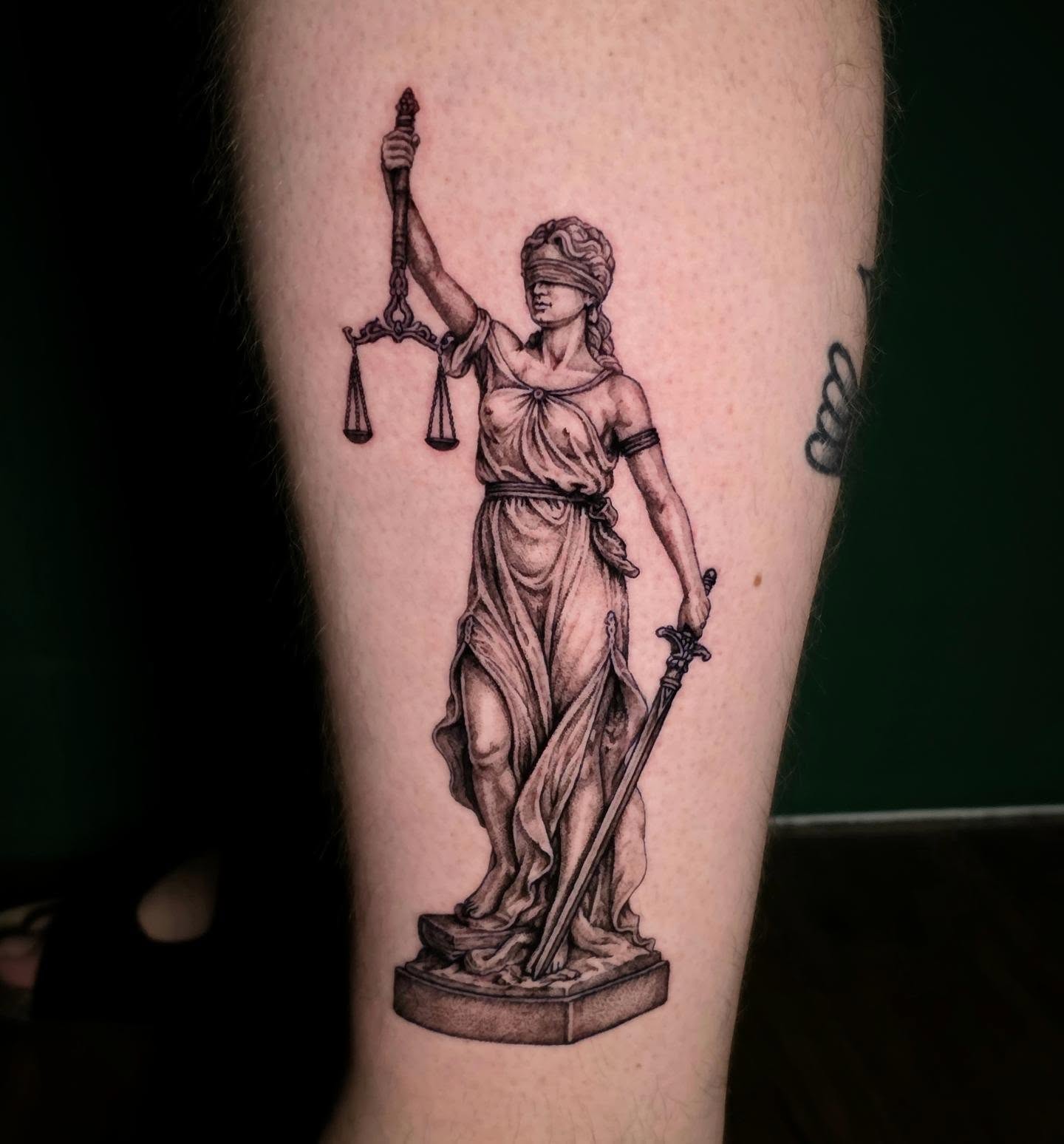 Statue of justice realism tattoo on the forearm by Nick de Hoyos