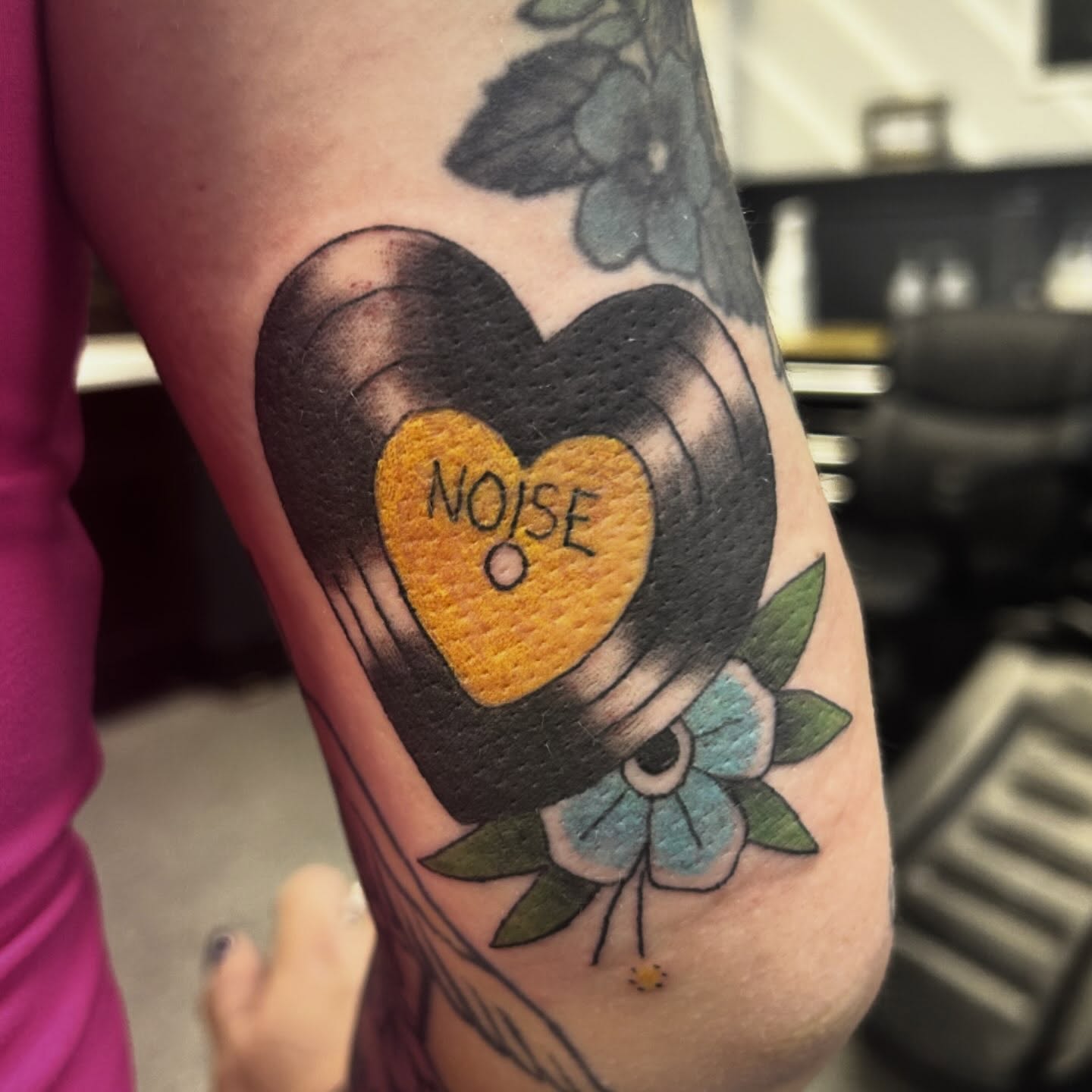 Heart-shaped record American traditional tattoo on the forearm by Gillian
