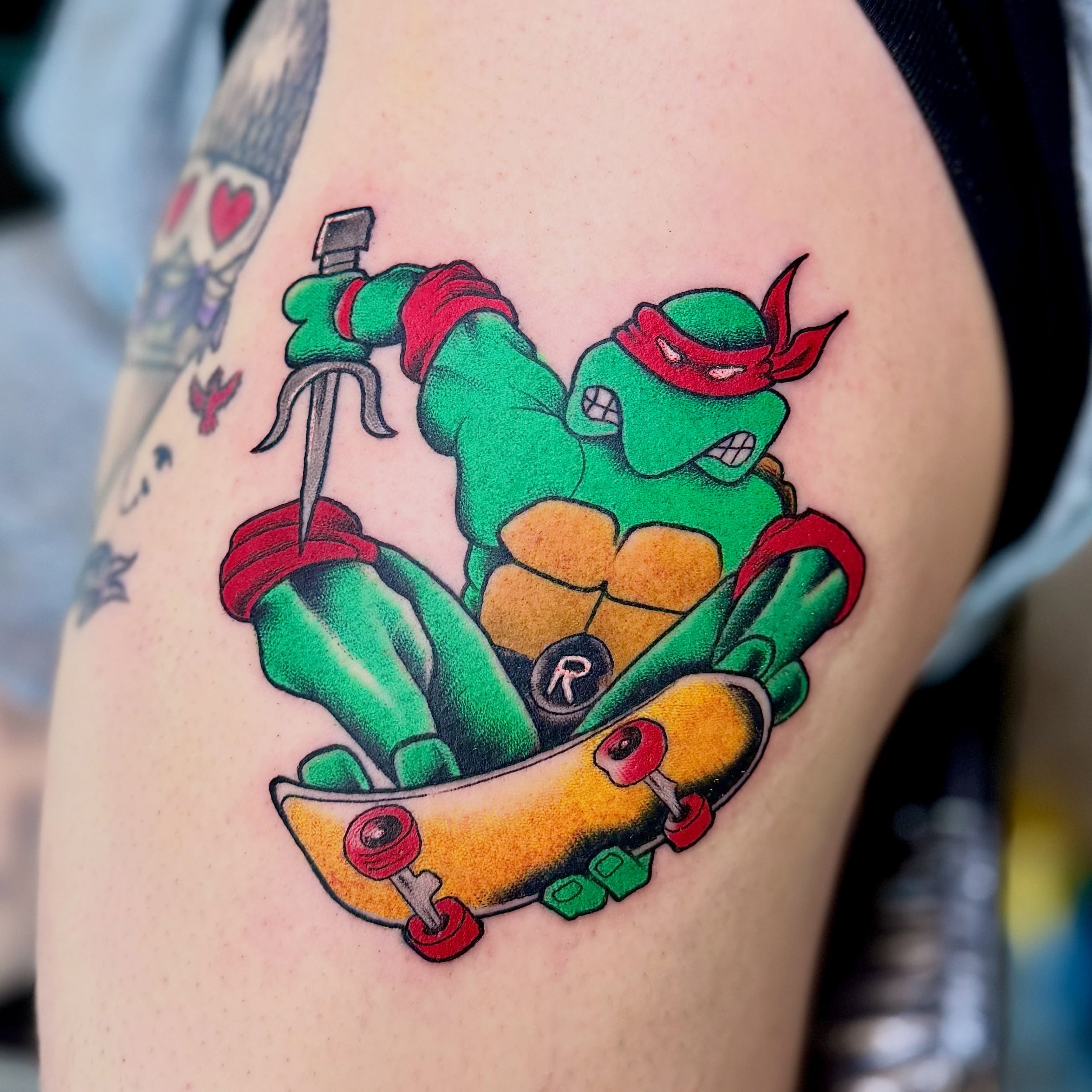 Teenage mutant ninja turtle on skateboard new school tattoo on the thigh by Jamie Hall, Kansas City, Missouri