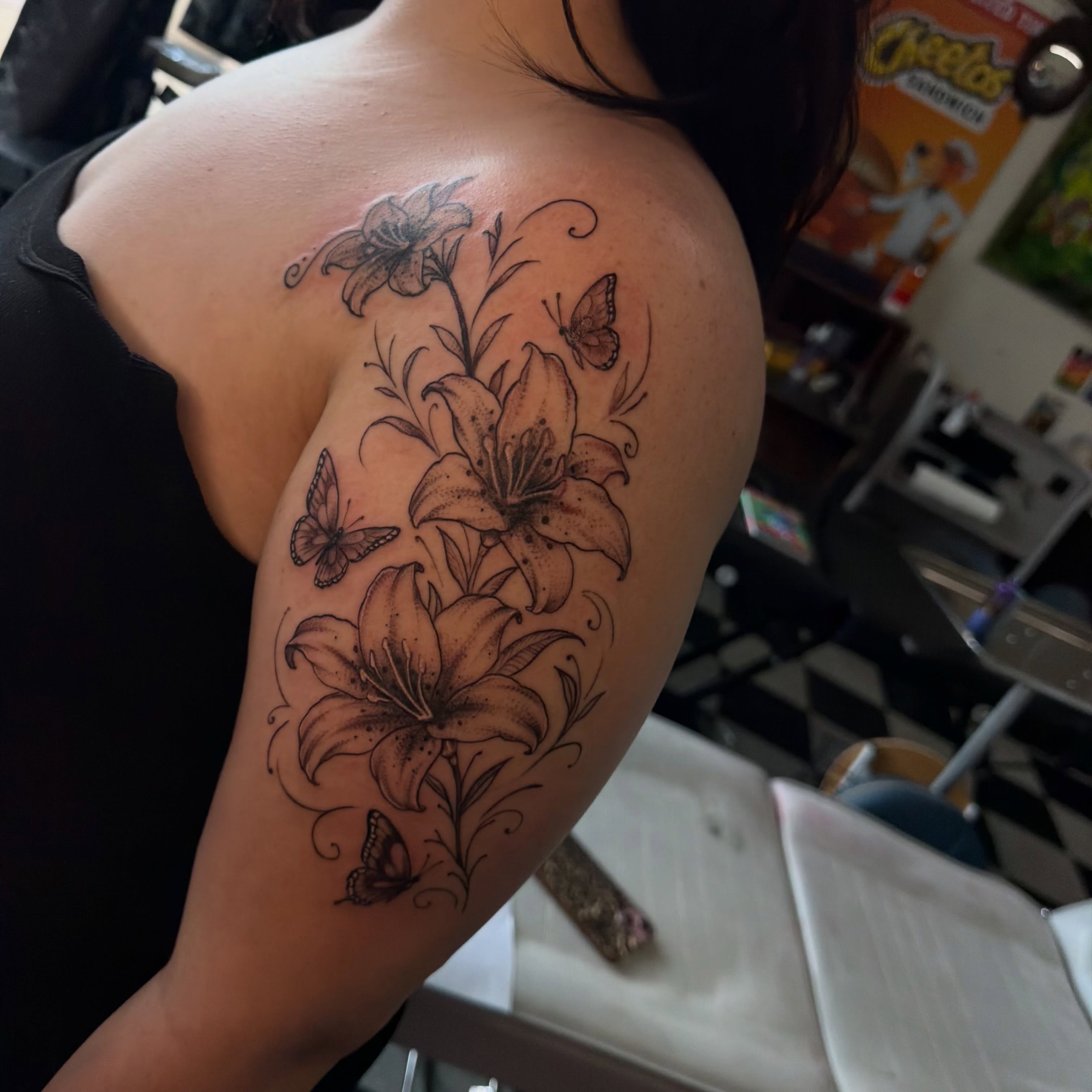 Lilies and butterflies realism tattoo on the shoulder by Nina Nichole