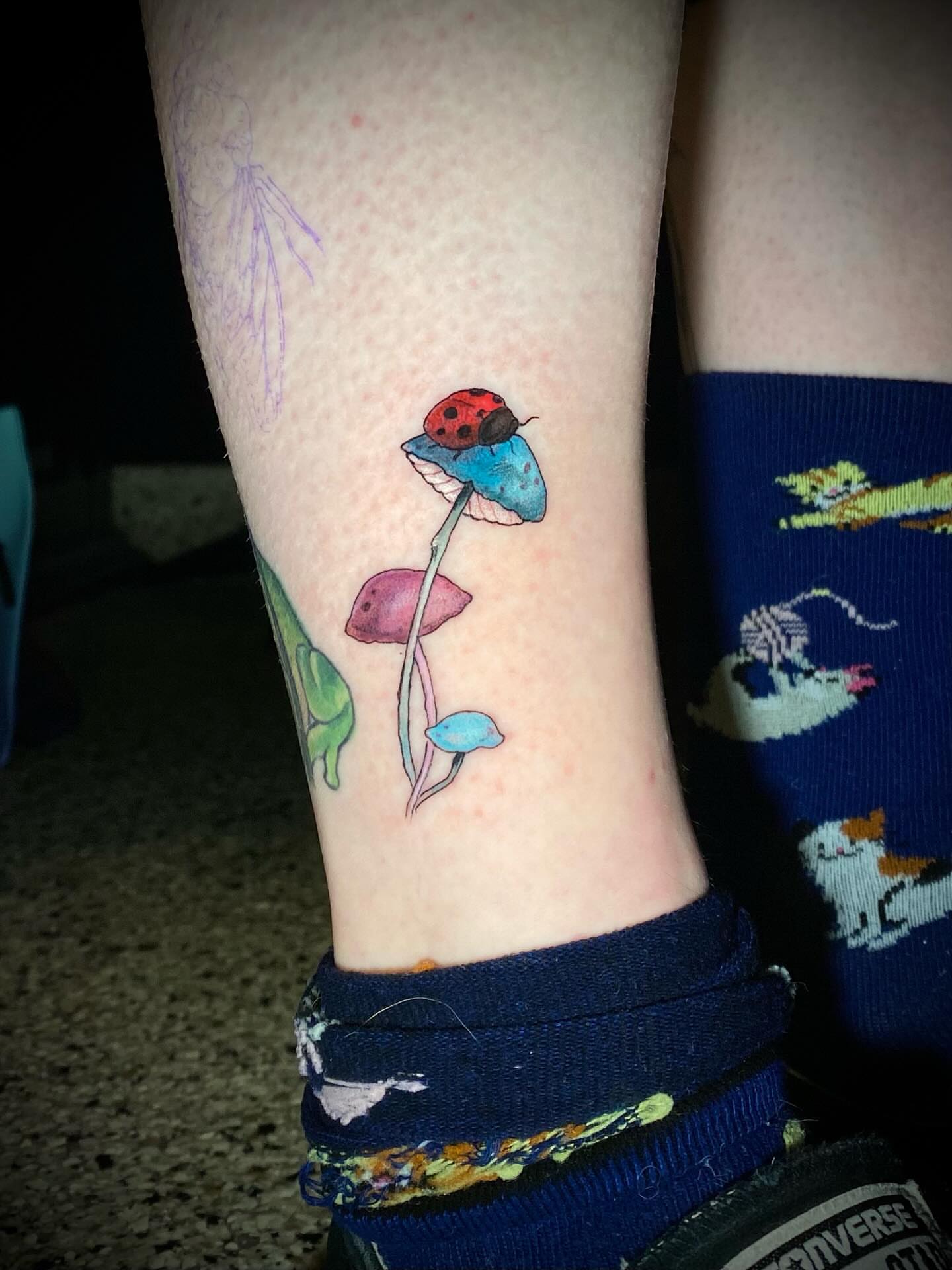 Mushroom and ladybug watercolor tattoo on the forearm by Olivia Scott - Kansas Tattoo Artist