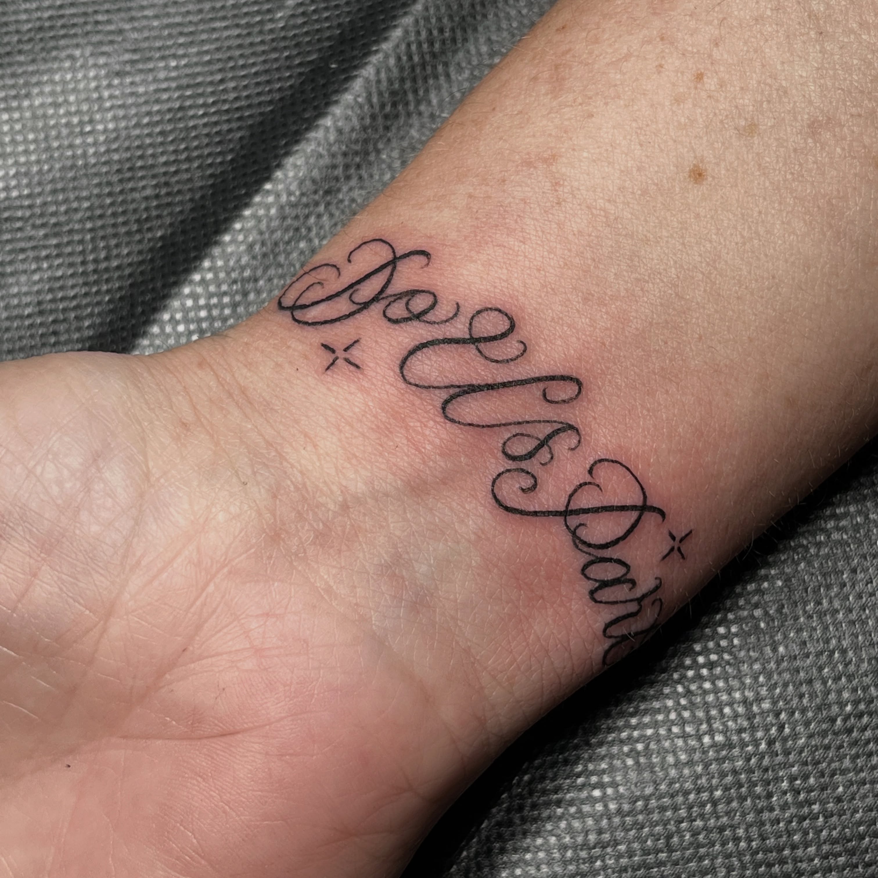 Belle & Dart lettering script tattoo on the forearm by christina diaz