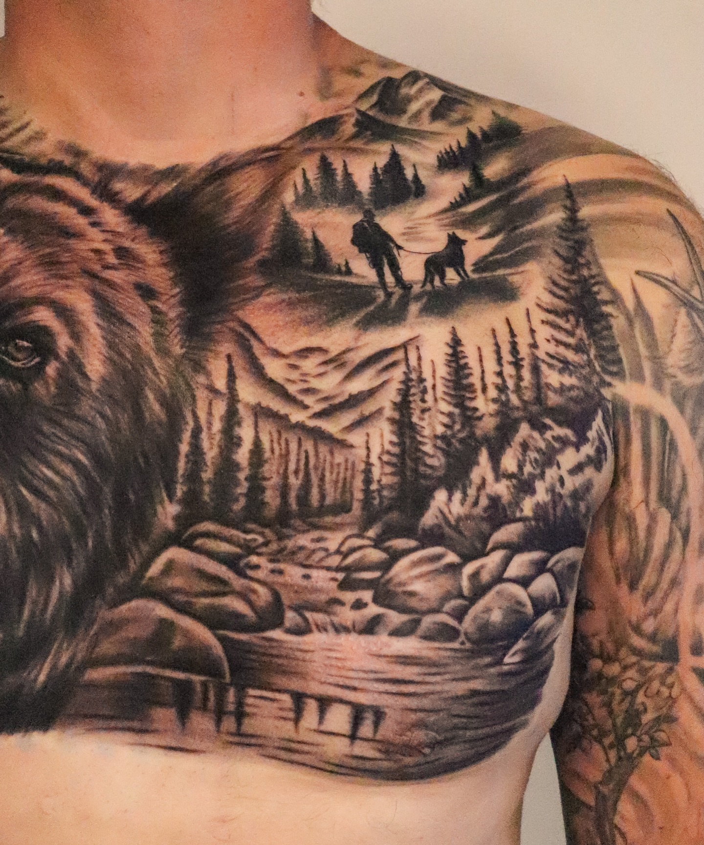 Mountain landscape realism tattoo on the chest by Angel Tattoos