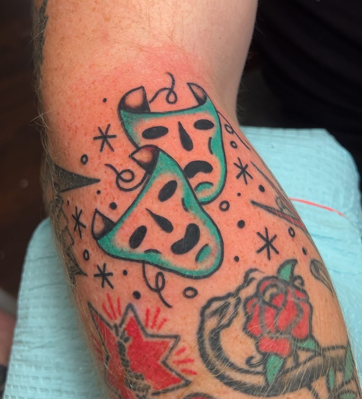 Mask and rose American traditional tattoo on the forearm by Mat Helton, Fairborn, Ohio