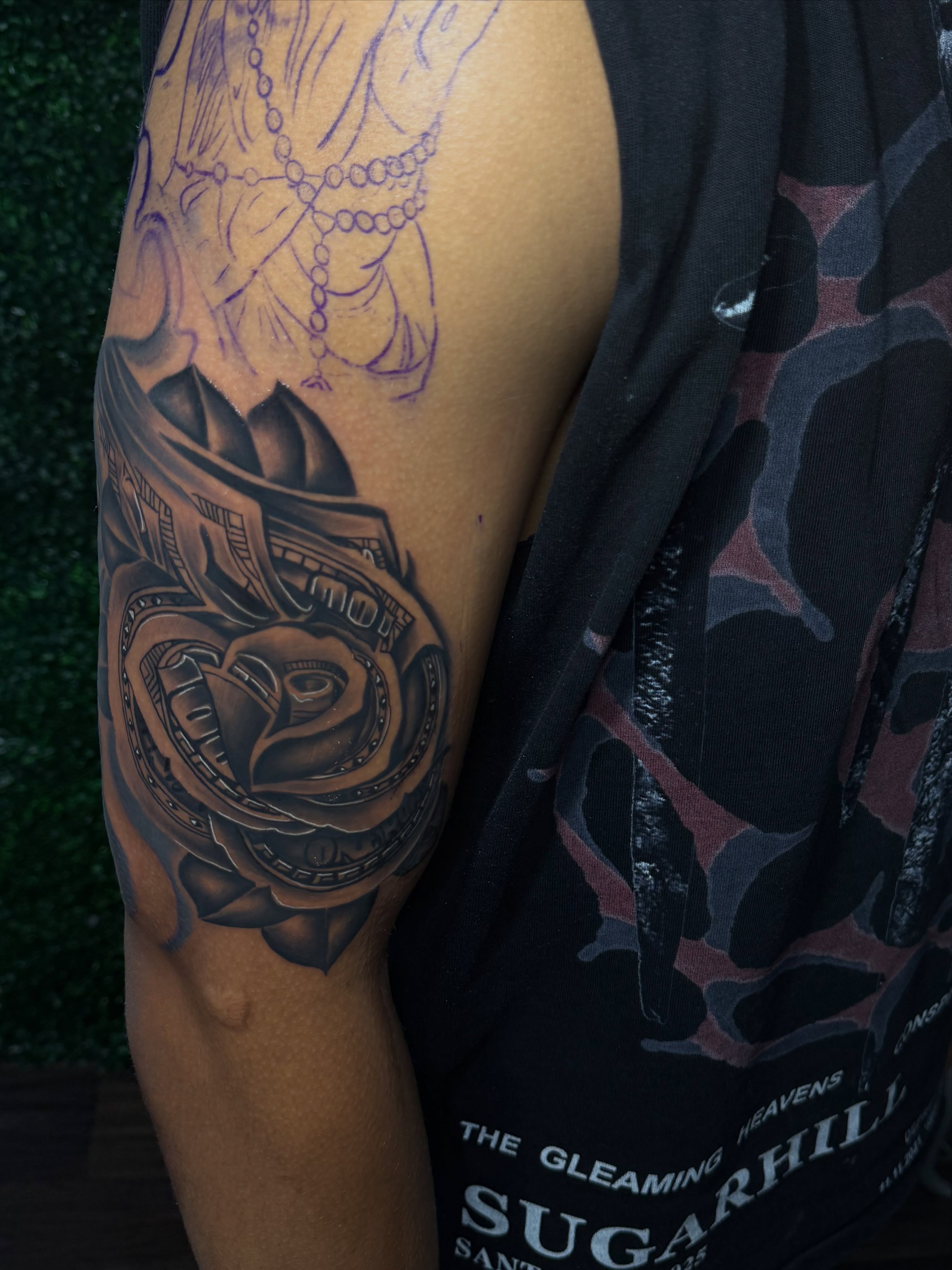 Mechanical rose geometric tattoo on the upper arm by Deonte Dwayne Durham