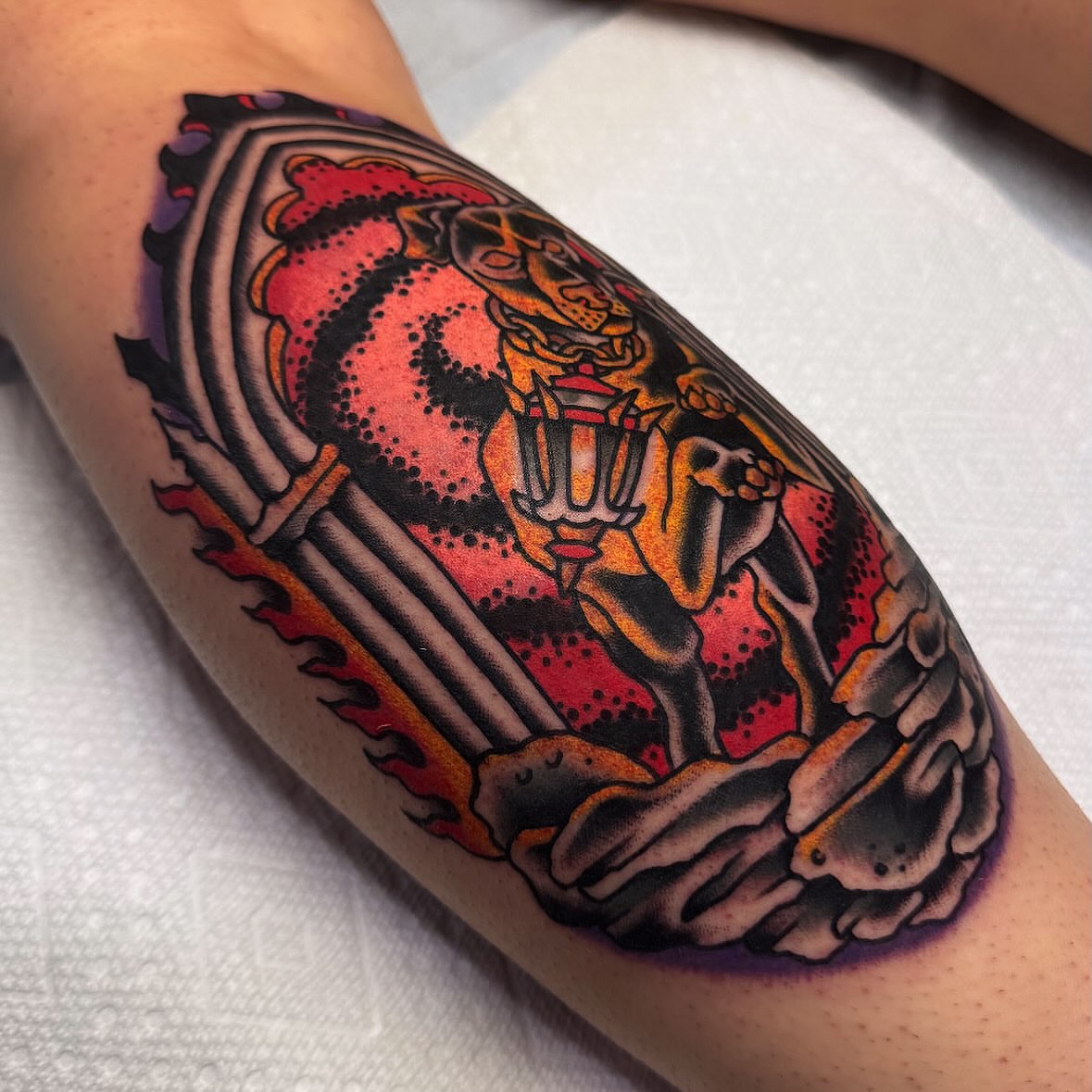 Tiger American traditional tattoo on the forearm by Larry Love