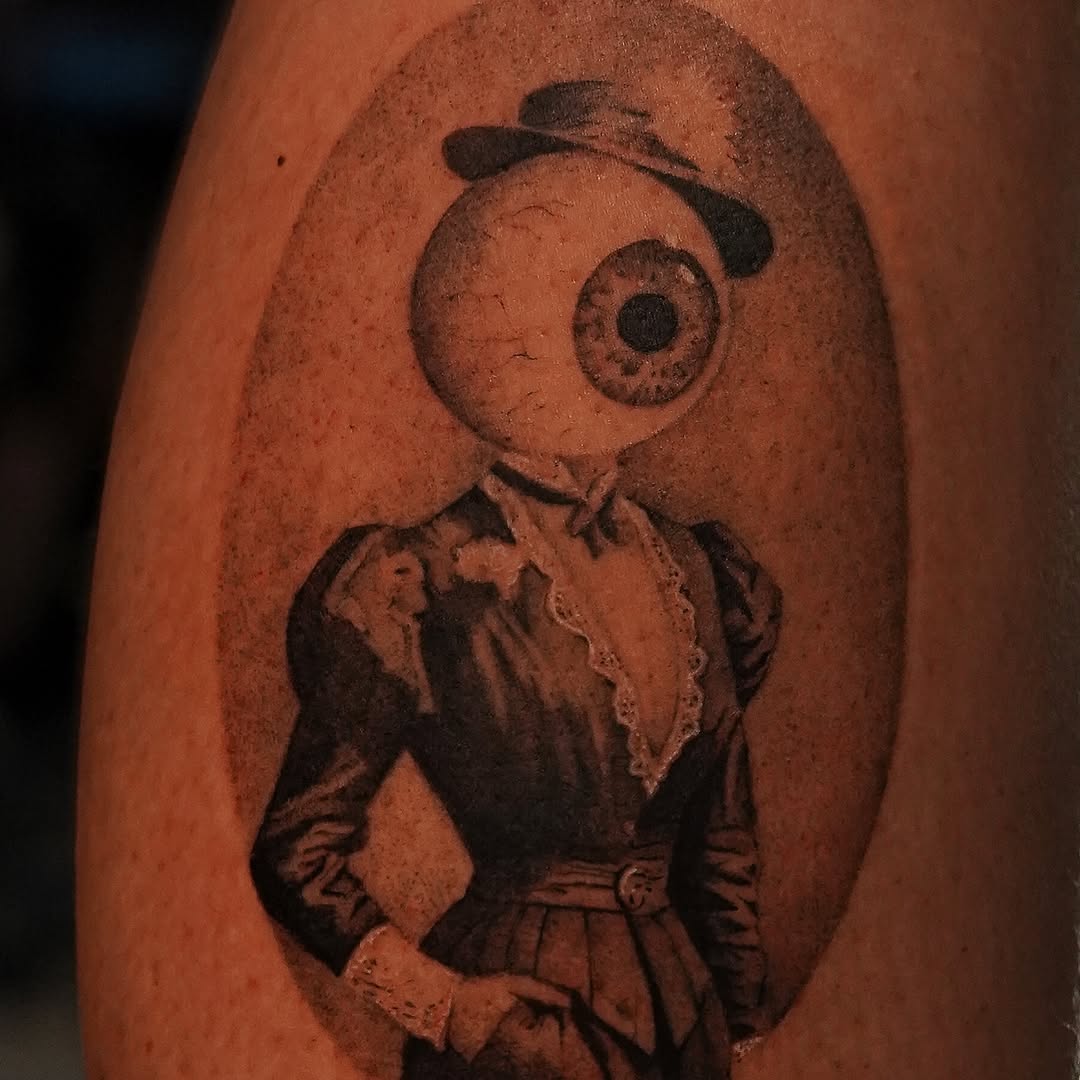 Eye with Victorian attire black and grey tattoo on the forearm by Keely Thompson