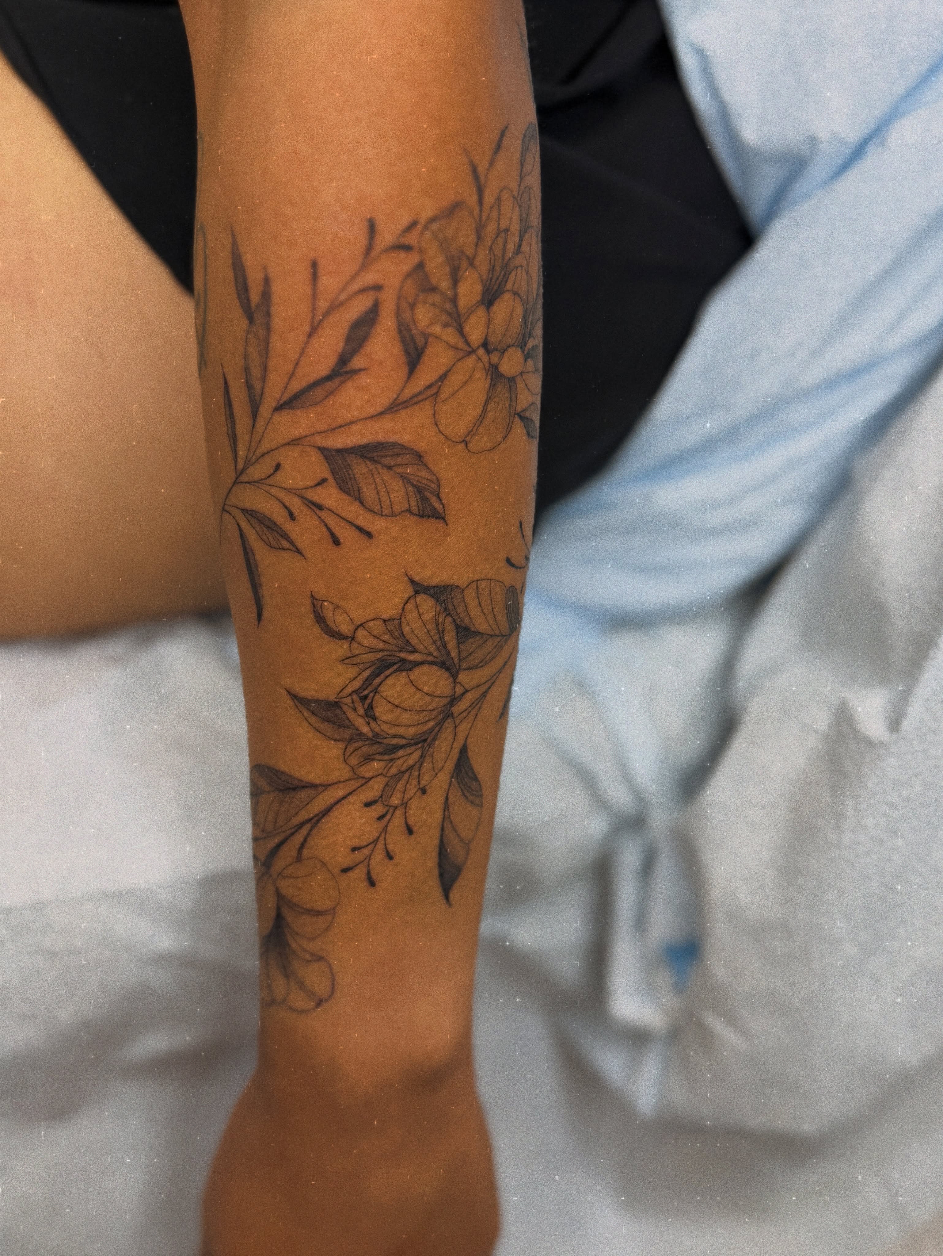 Floral design black and grey tattoo on the forearm by Melissa Rose Moya