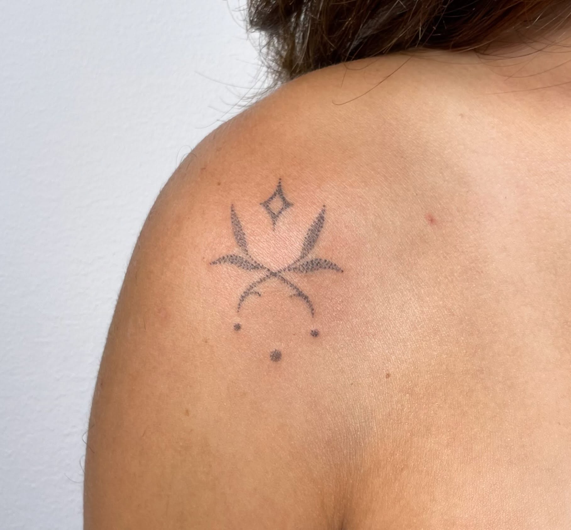 Geometric symbol dotwork tattoo on the shoulder by Quin