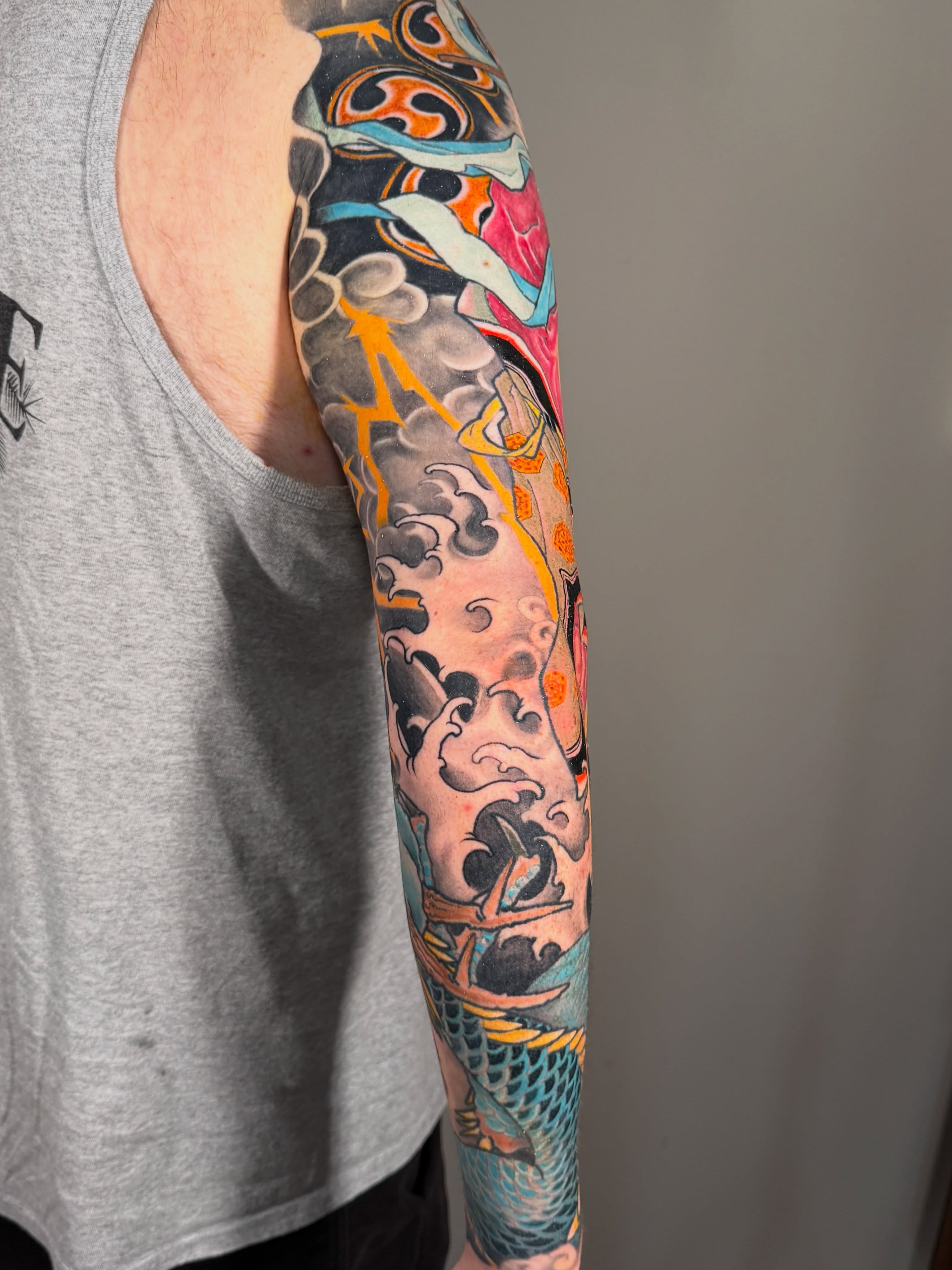 Koi fish and waves japanese irezumi tattoo on the forearm by Eric James, Phoenix, Arizona
