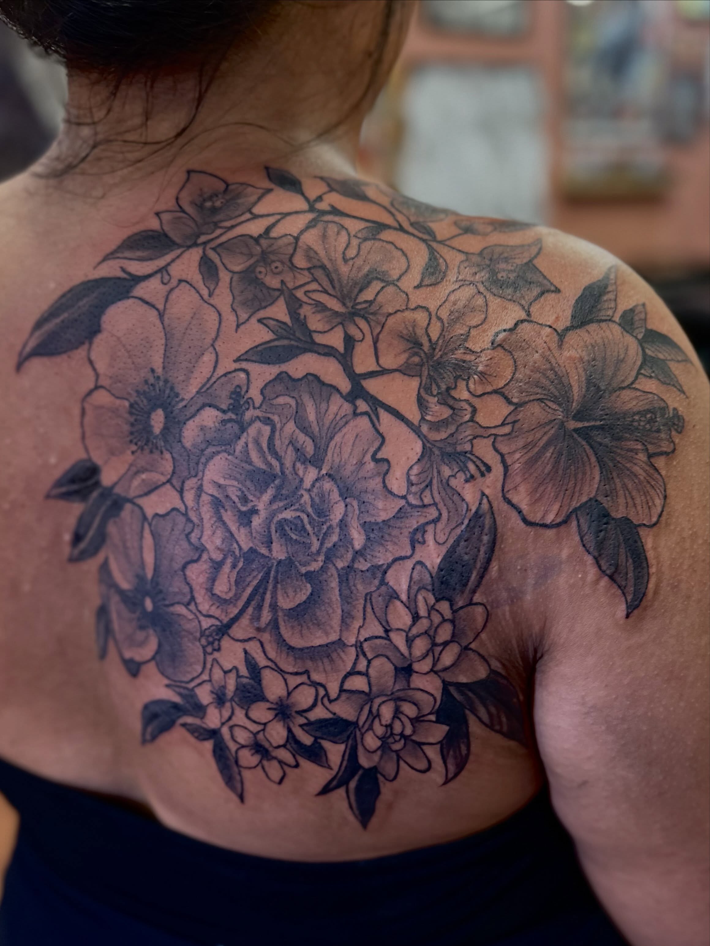 Floral bouquet black and grey tattoo on the back by Mathilda Quynh
