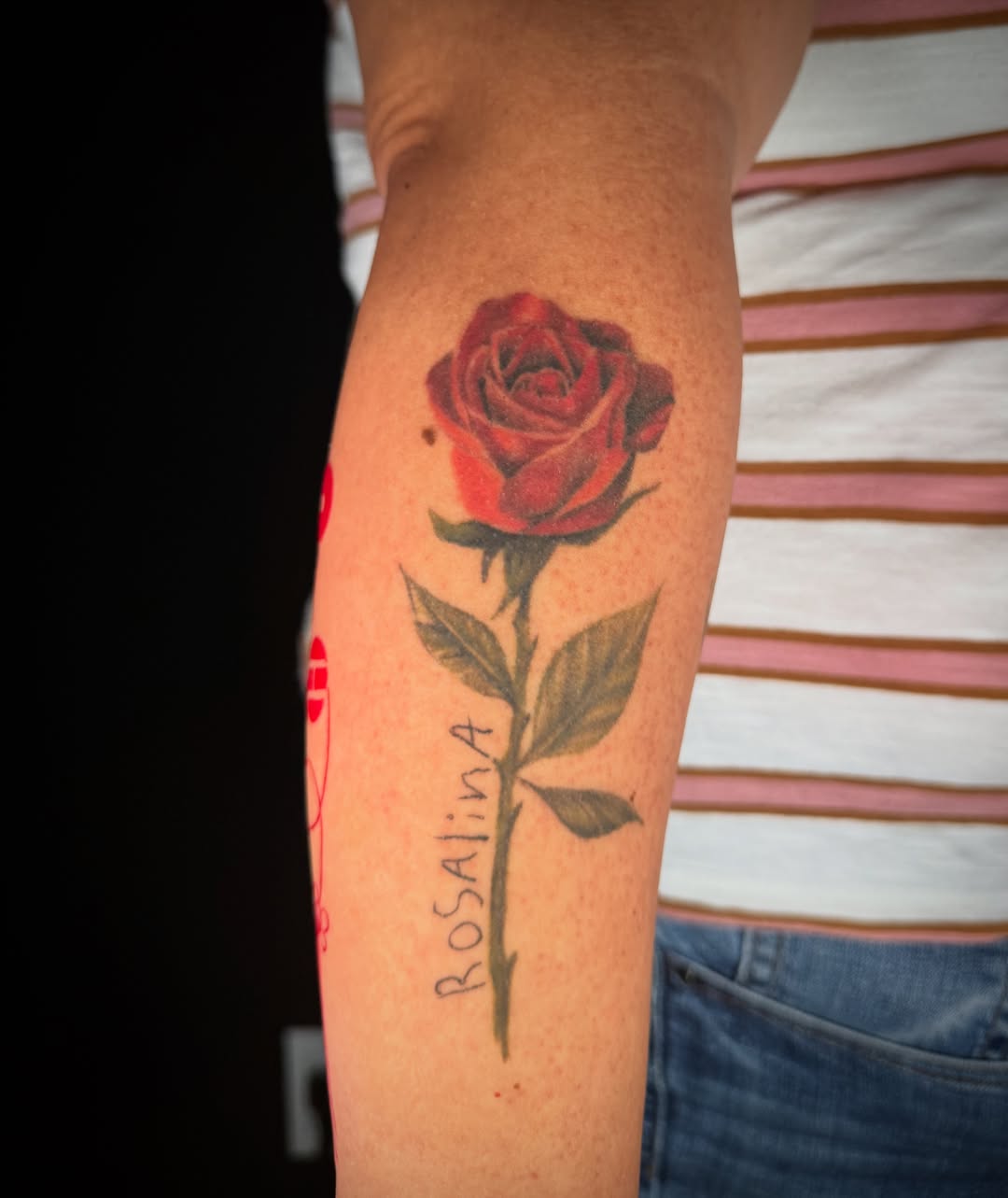 Red rose realism tattoo on the forearm by Monica Gonzalez
