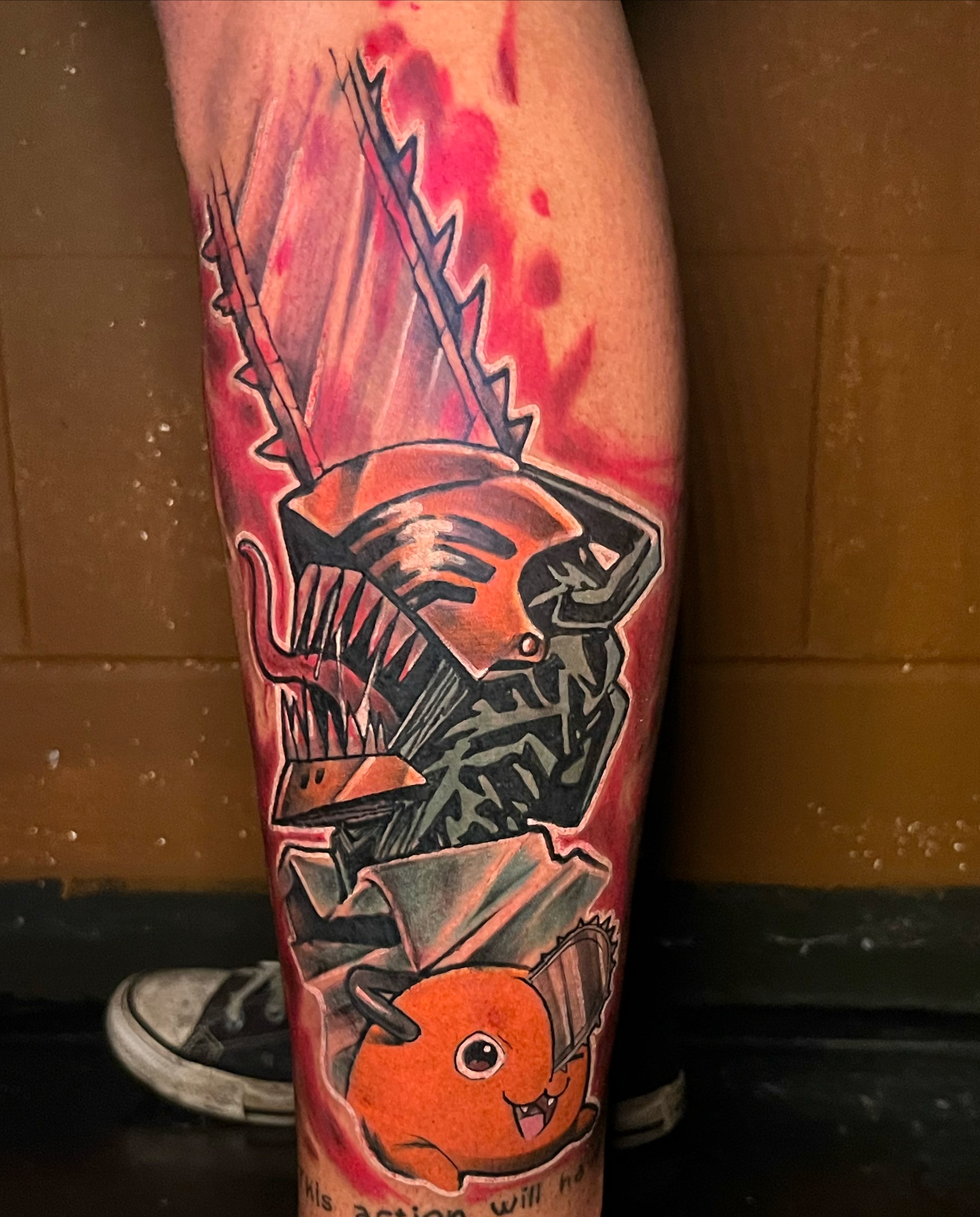 Chainsaw and pumpkin dark realism tattoo on the calf by Darius Armour (Tattoo Artist)