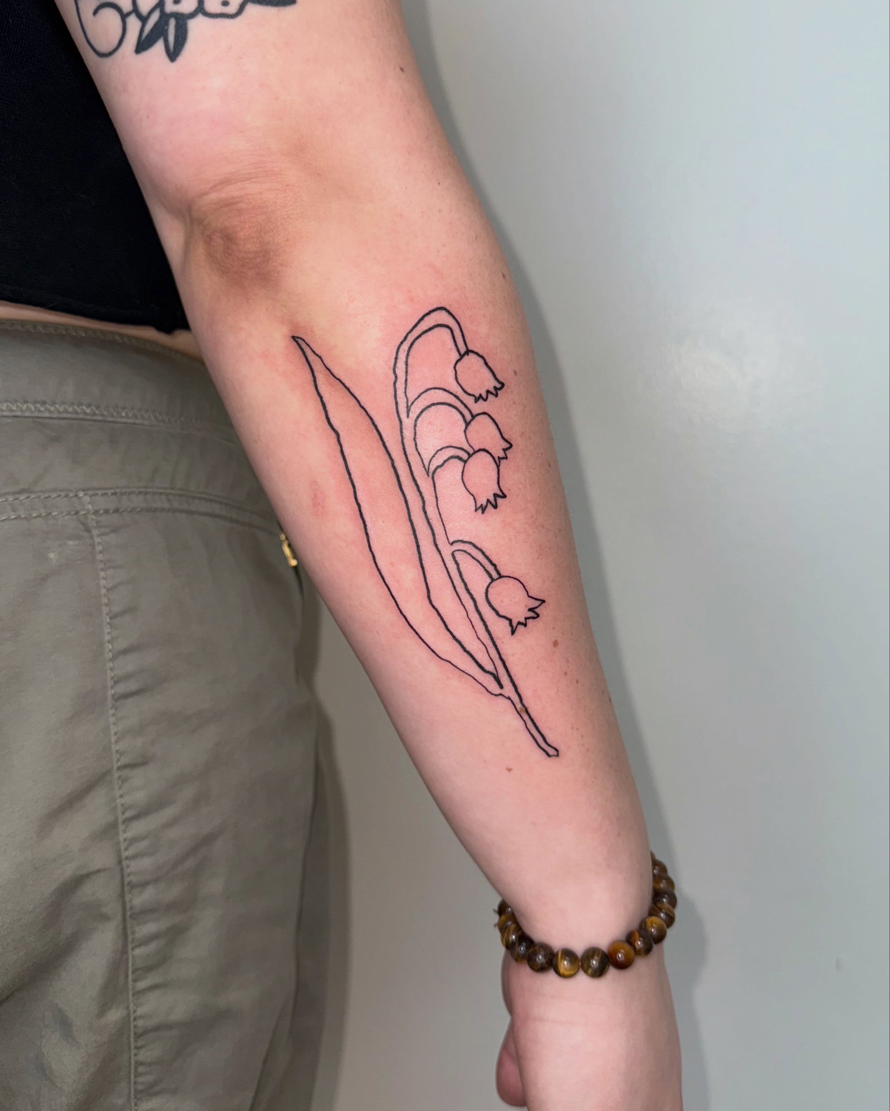 Lily of the valley fine line tattoo on the forearm by 림구타투
