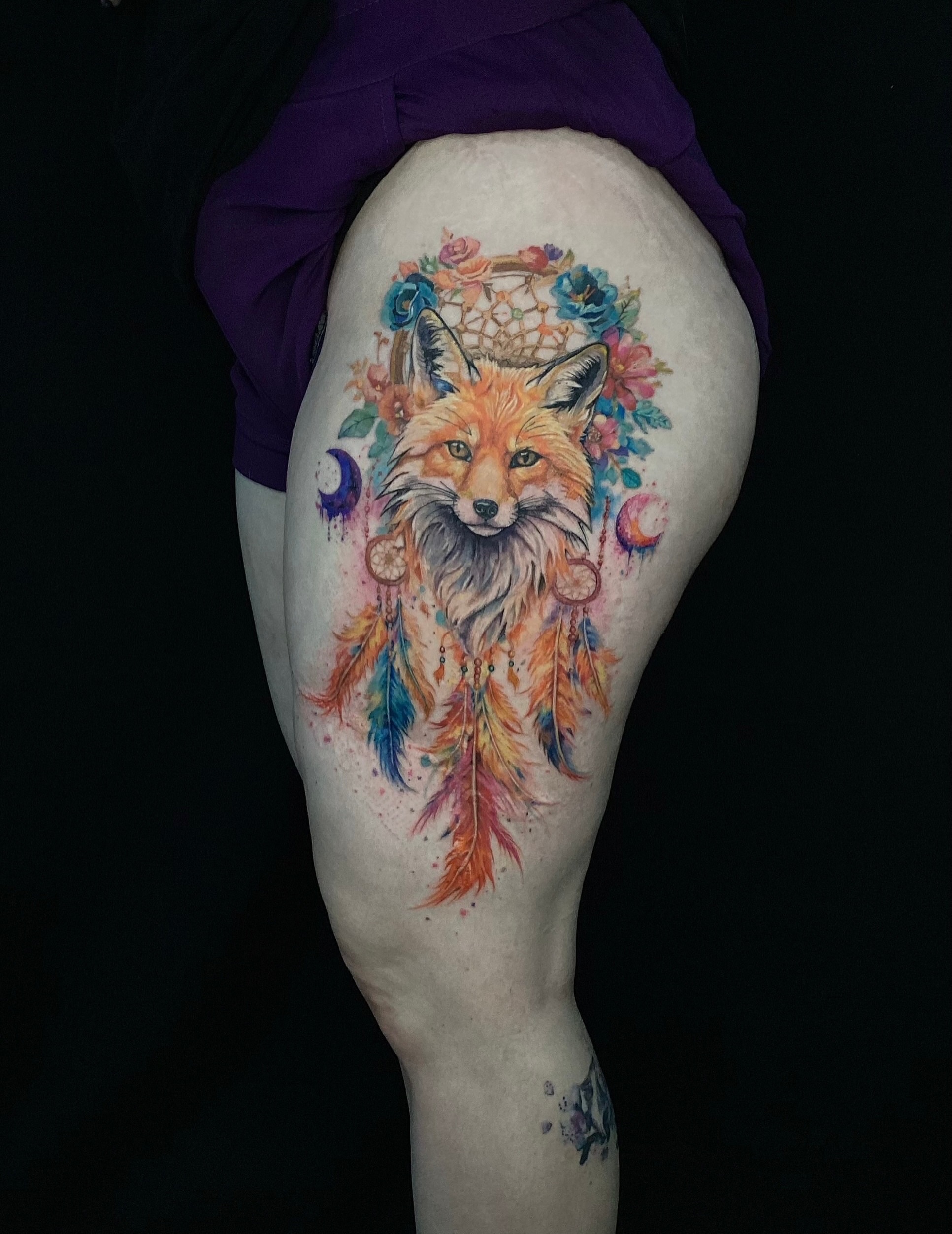 Fox with dreamcatcher watercolor tattoo on the thigh by Alexey Molyarenko