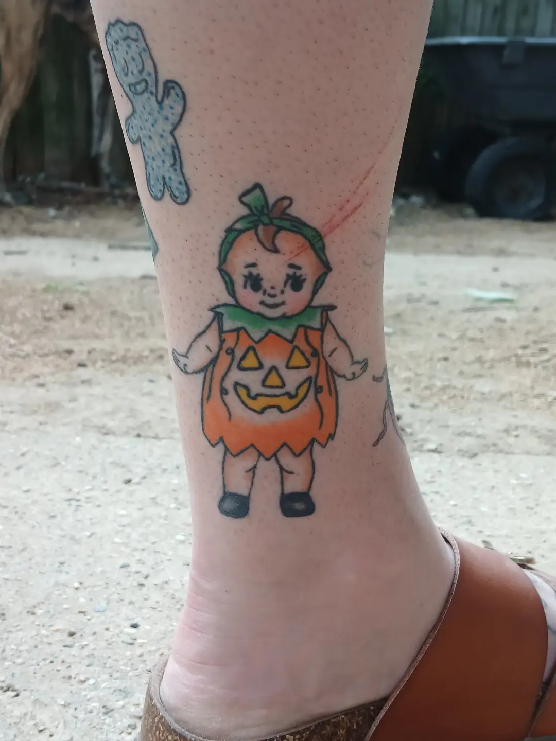 Pumpkin baby illustrative tattoo on the leg by Amber Tattoos