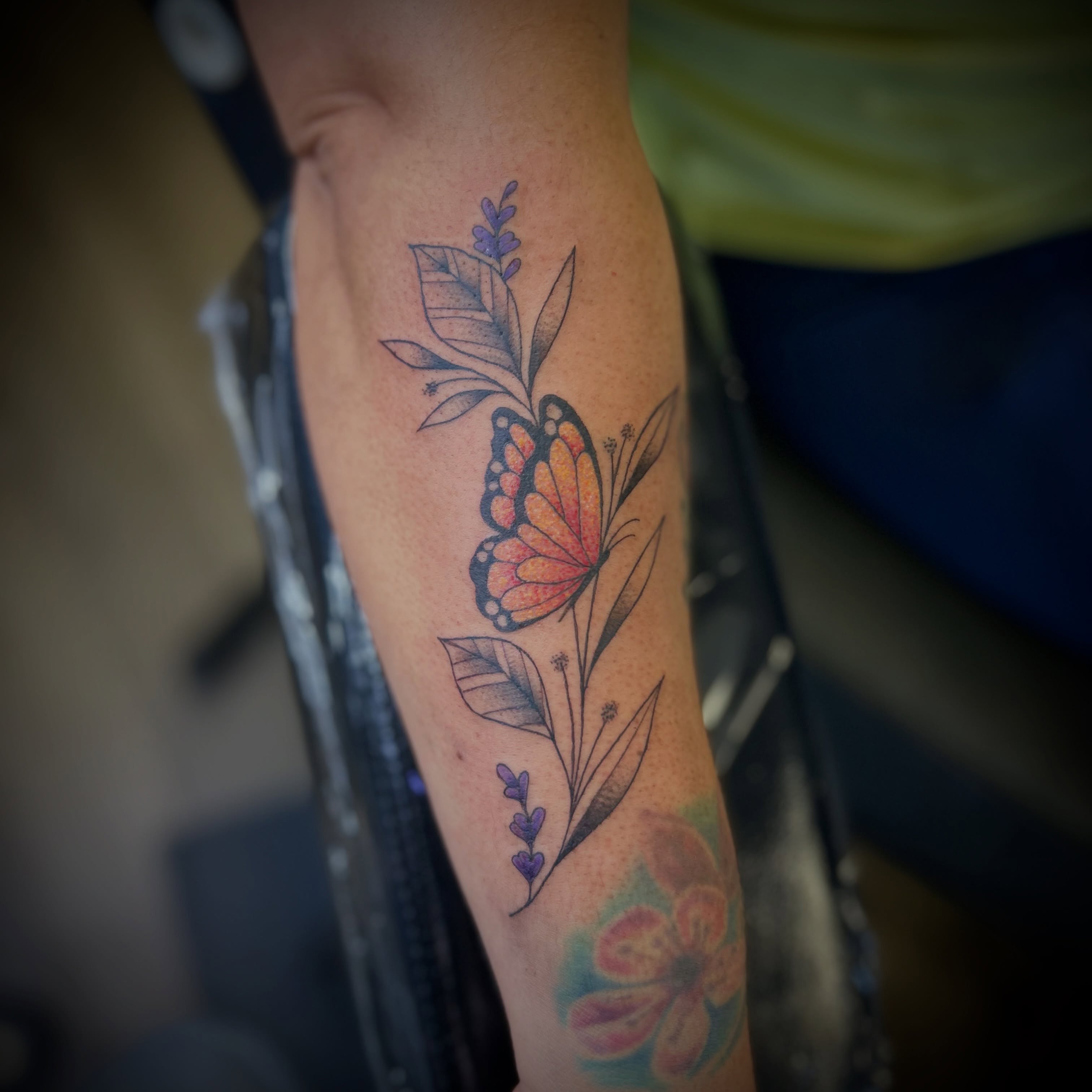 Butterfly and floral arrangement new school tattoo on the forearm by Browtique & Ink, Clearwater, Florida
