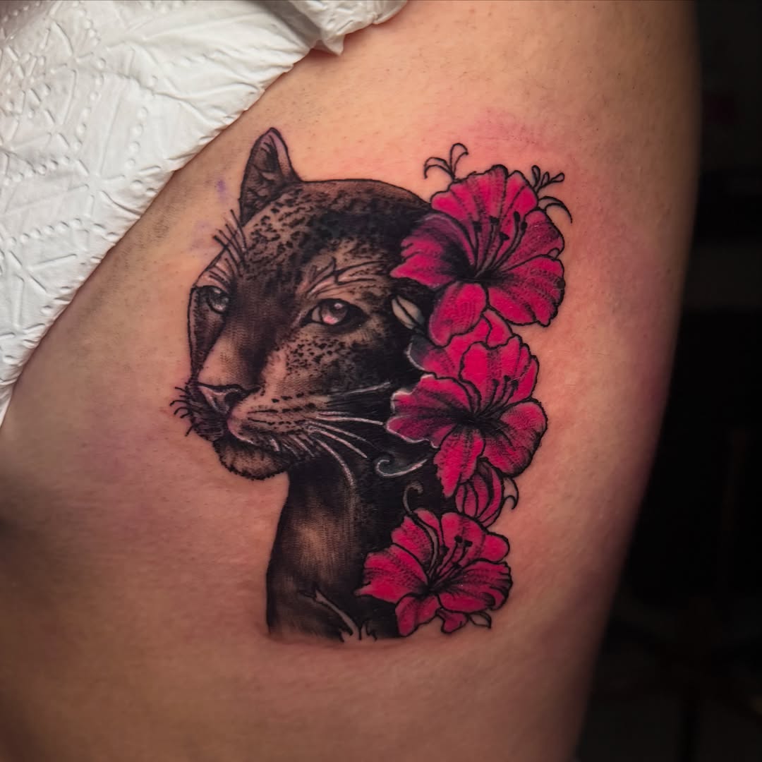 Panther with flowers realism tattoo on the thigh by Anghel Patricia