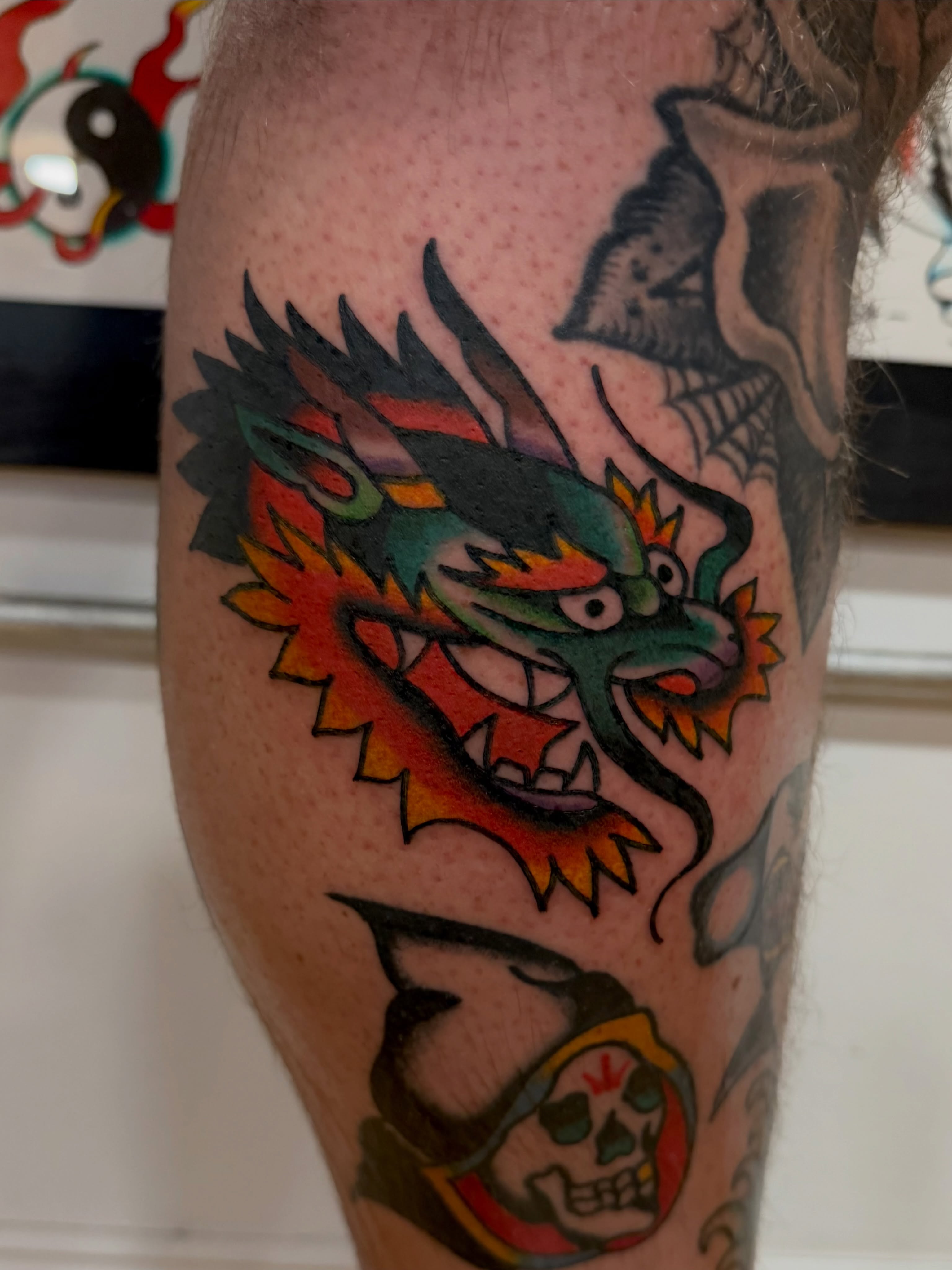 Dragon American traditional tattoo on the calf by Steven