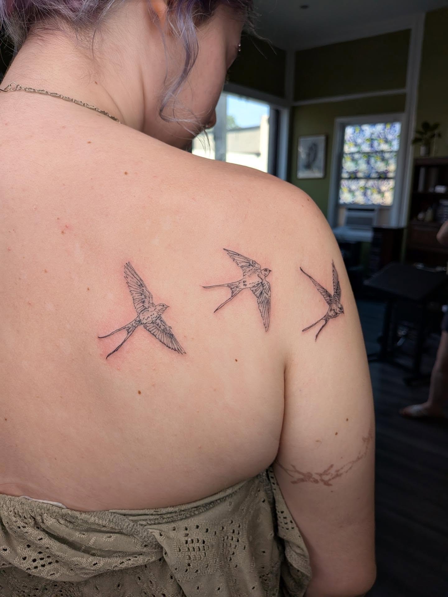 Swallows black and grey tattoo on the shoulder by Ryan