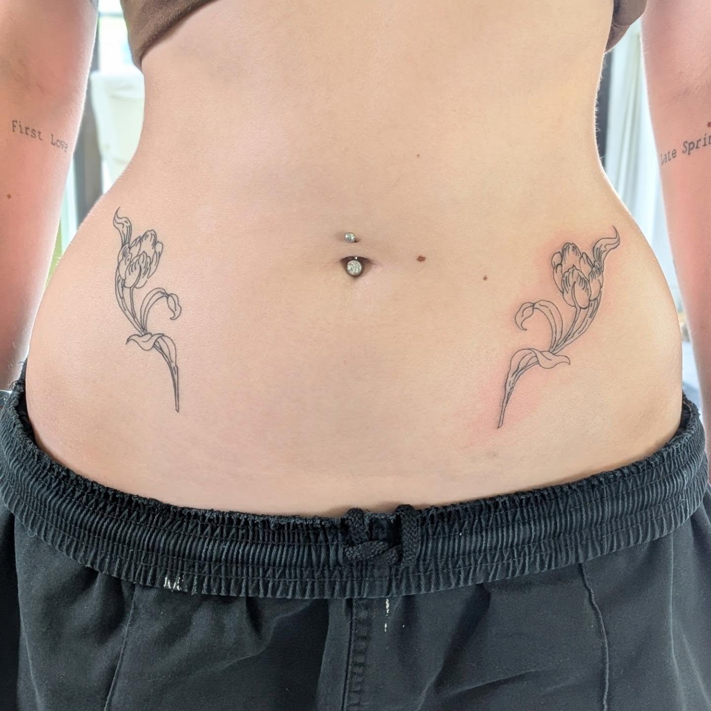 Tulips black and grey tattoo on the torso by Ryan